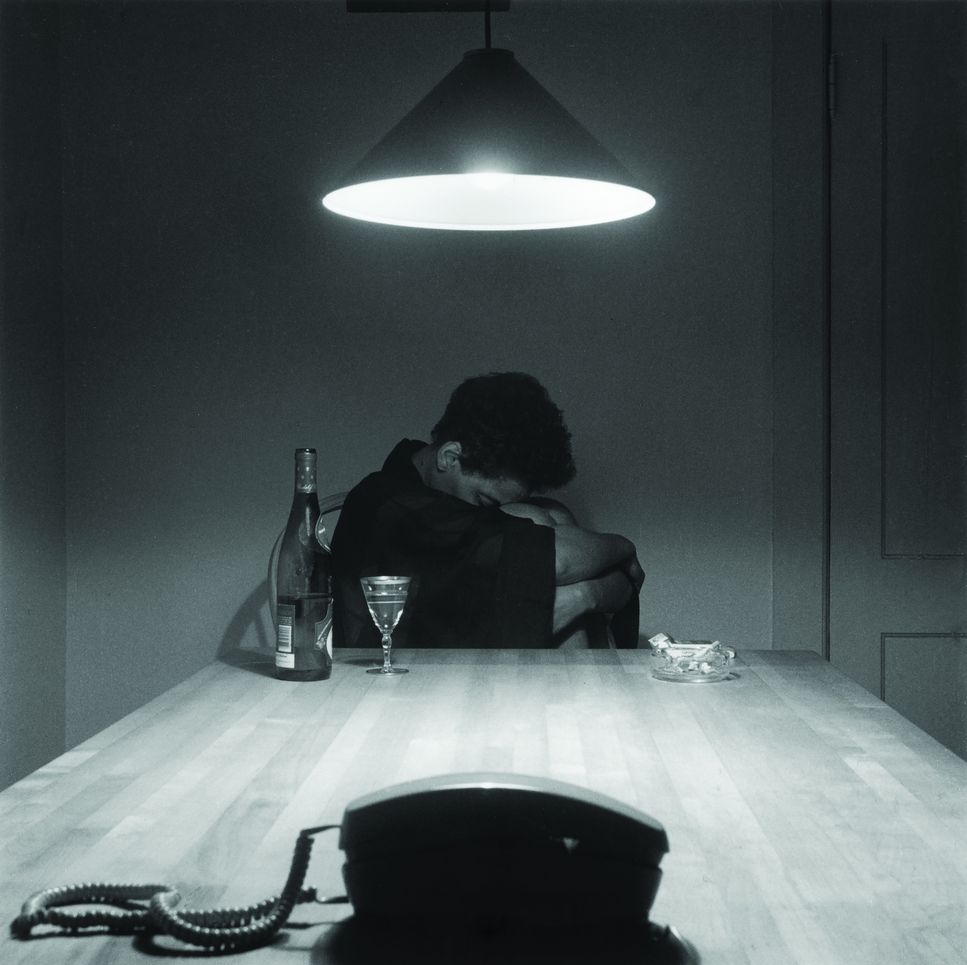 Artist Carrie Mae Weems appears in her Untitled (Woman and Phone), 1990. Part of her career-making kitchen table series.