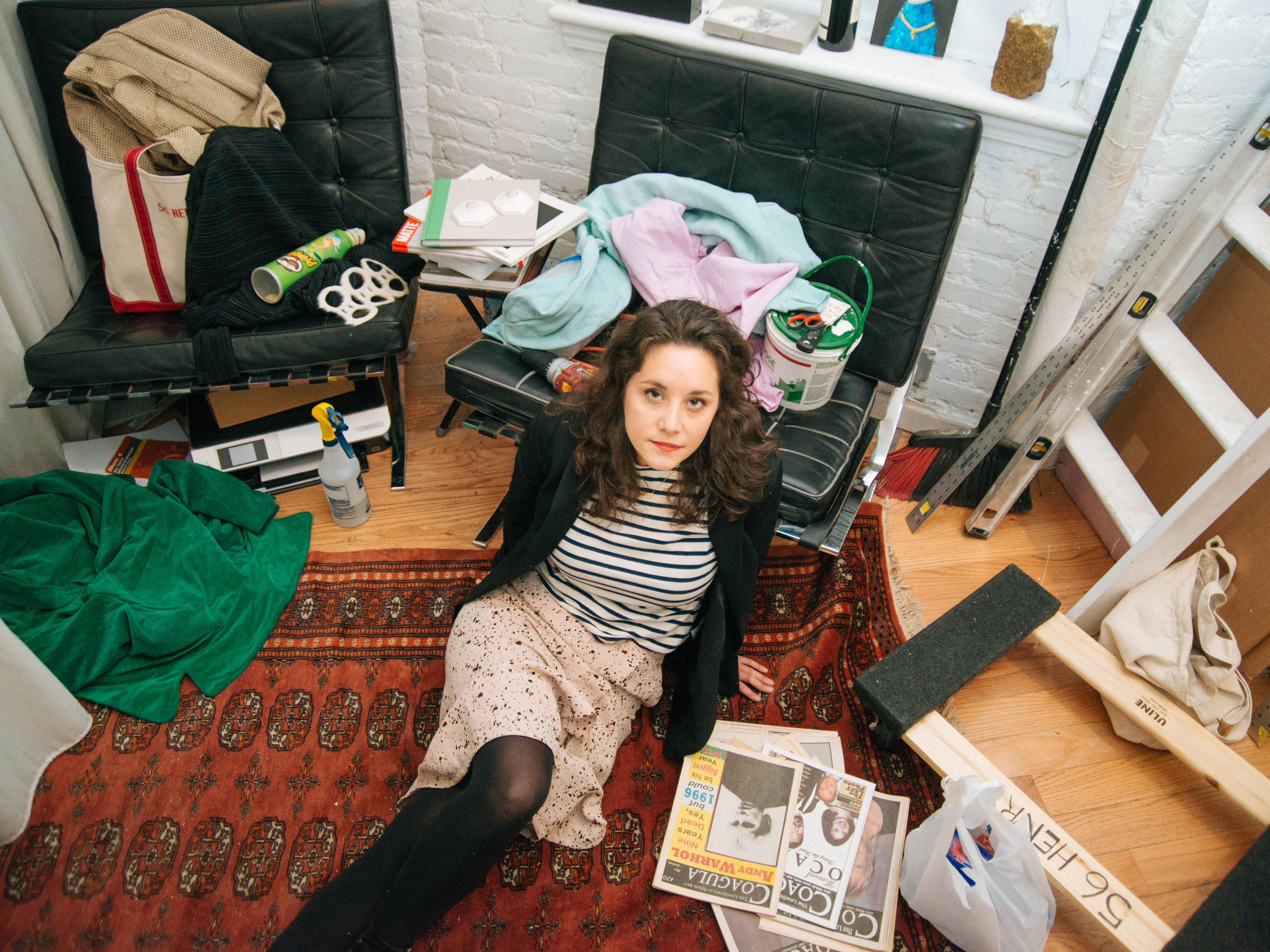 Art dealer Ellie Rines, styled by Hester Hodde, sits on the floor of her live/work space, 56 Henry, in Chinatown, New York. 