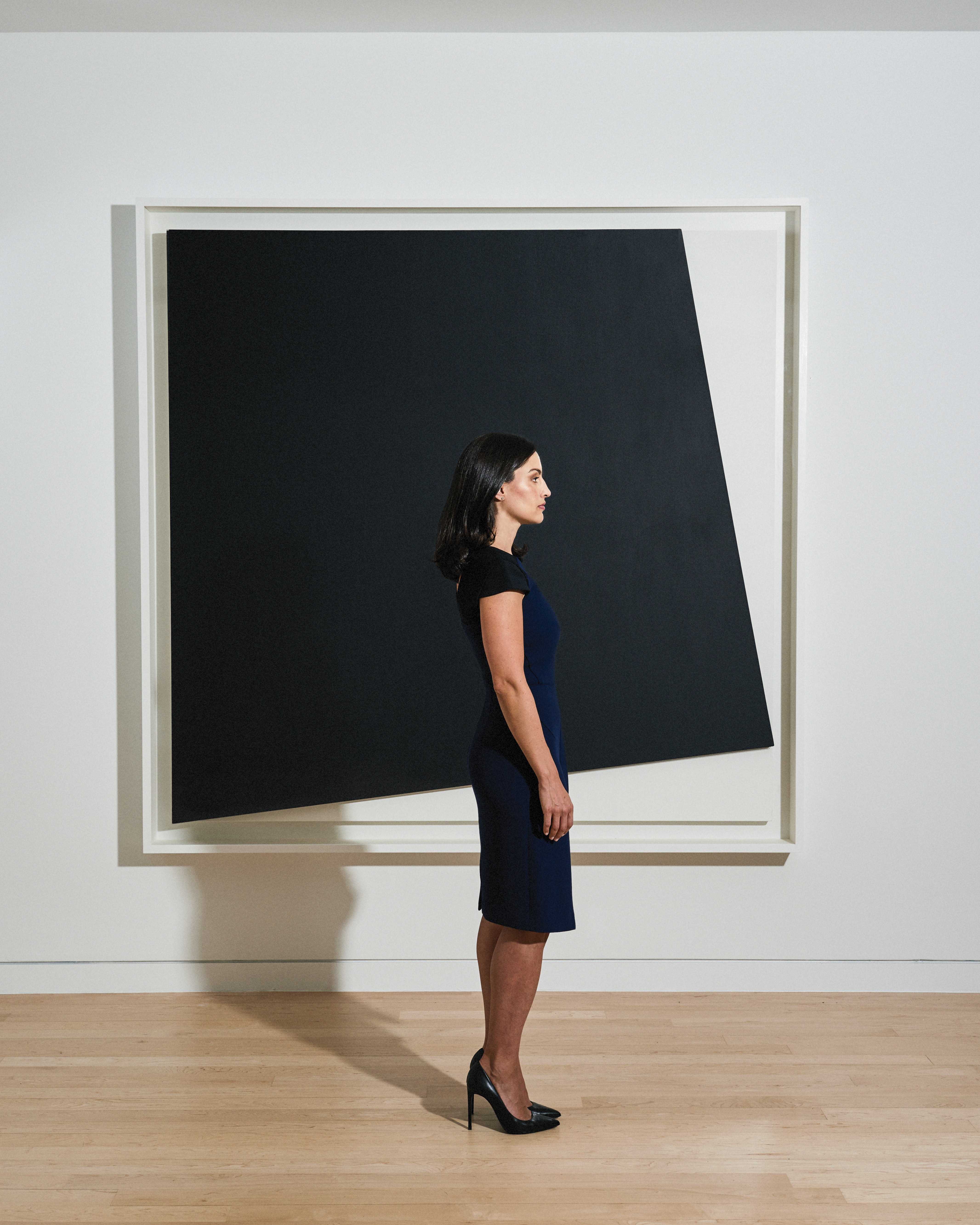 The FLAG Art Foundation Director Stephanie Roach in front of Ellsworth Kelly’s Black Relief with White, 2005, at Gagosian Gallery. Portrait by Kyle Dorosz. 