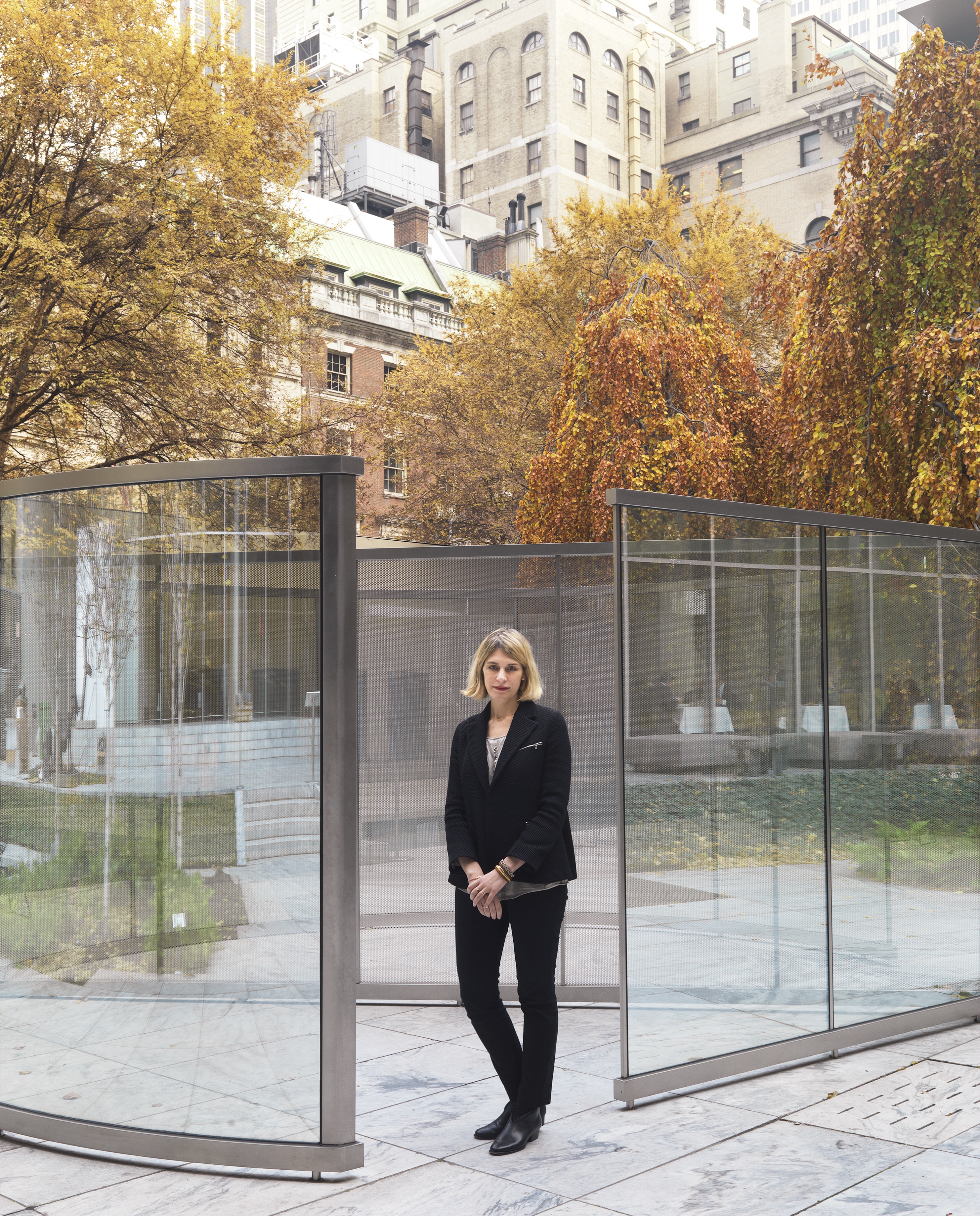 Janevski stands with the mirrored glass and perforated steel of Dan Graham's Child's Play, 2015–16 in MoMA's sculpture garden.