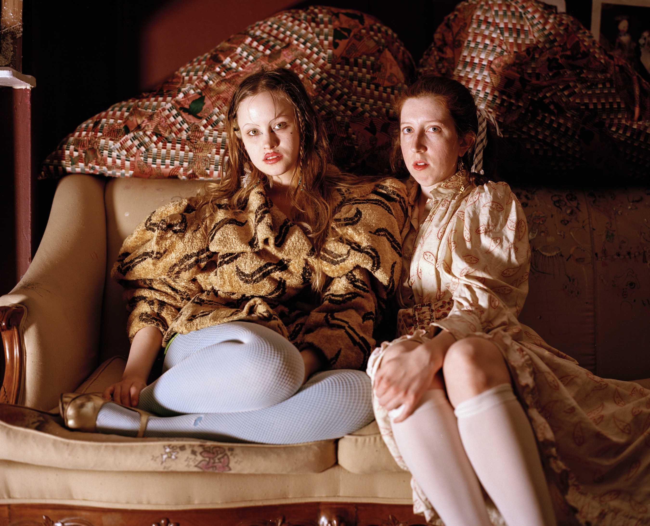 Mattie Rivkah Barringer and Amanda McGowan of Women’s History Museum sit on a couch of their own design.