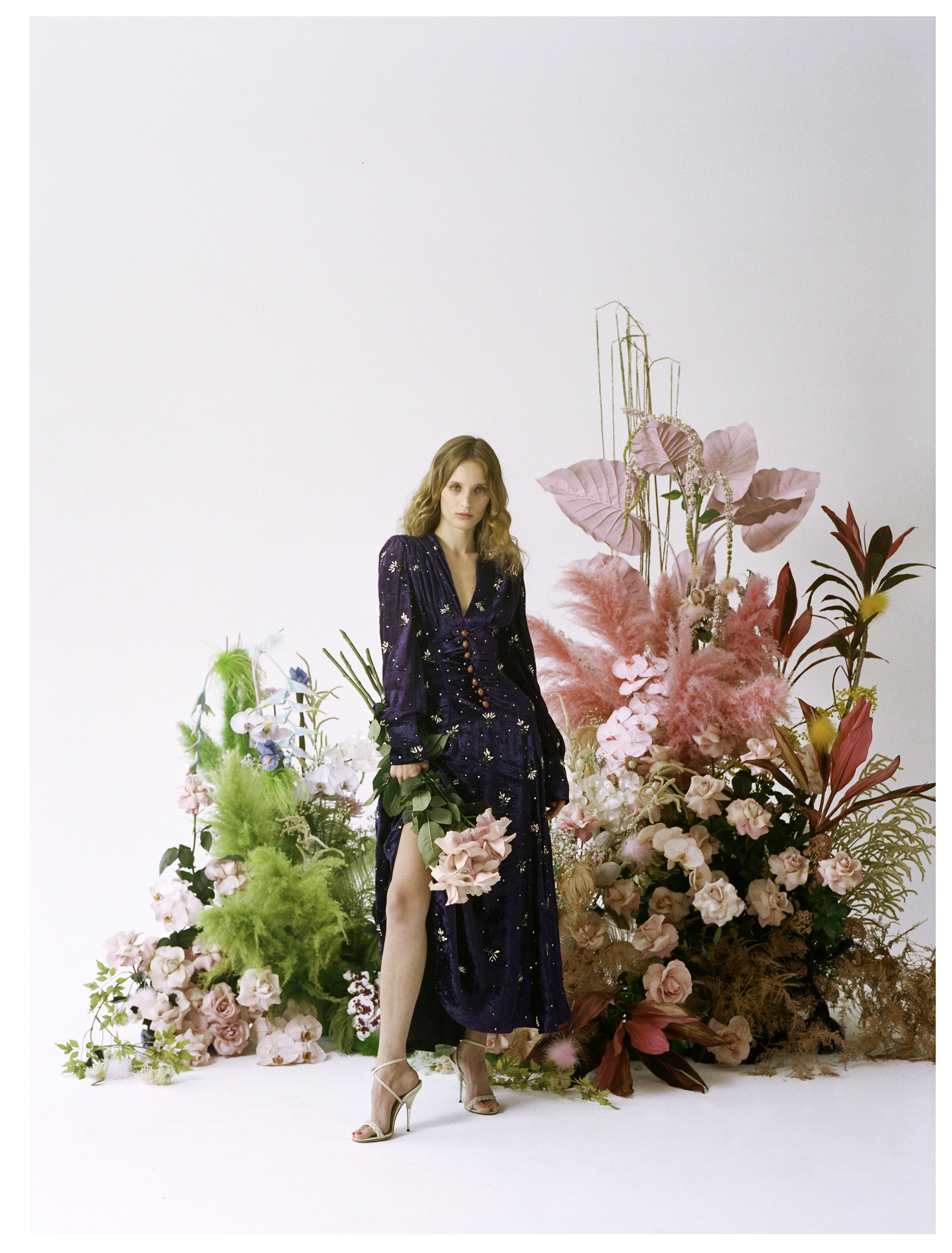 PETRA COLLINS IN GUCCI. BEHIND COLLINS IS A “FANTASY GARDEN” BY ARTIST BRITTANY ASCH.