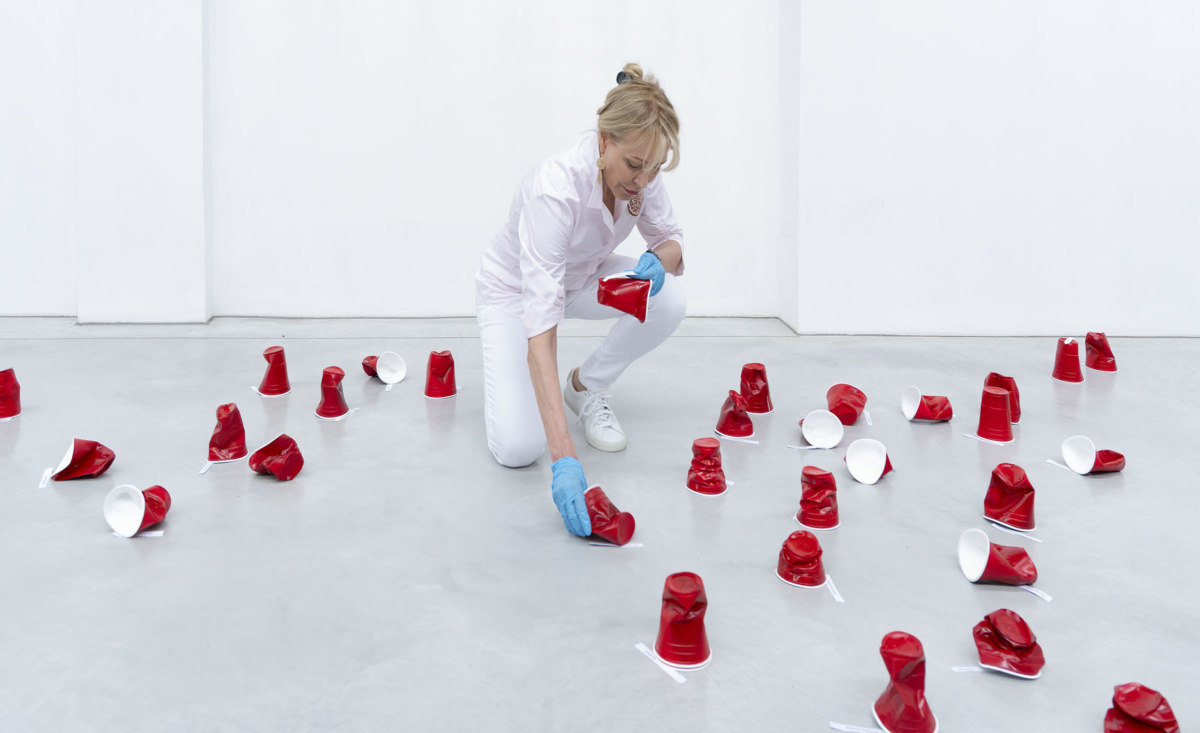 Paula Crown installing “The Architecture of Memory” at a 2,200-square-foot former glass factory in Venice. The preciously crafted ceramic replicas of disposable cups are a comment on consumer waste. Courtesy of PAHC/Studio.