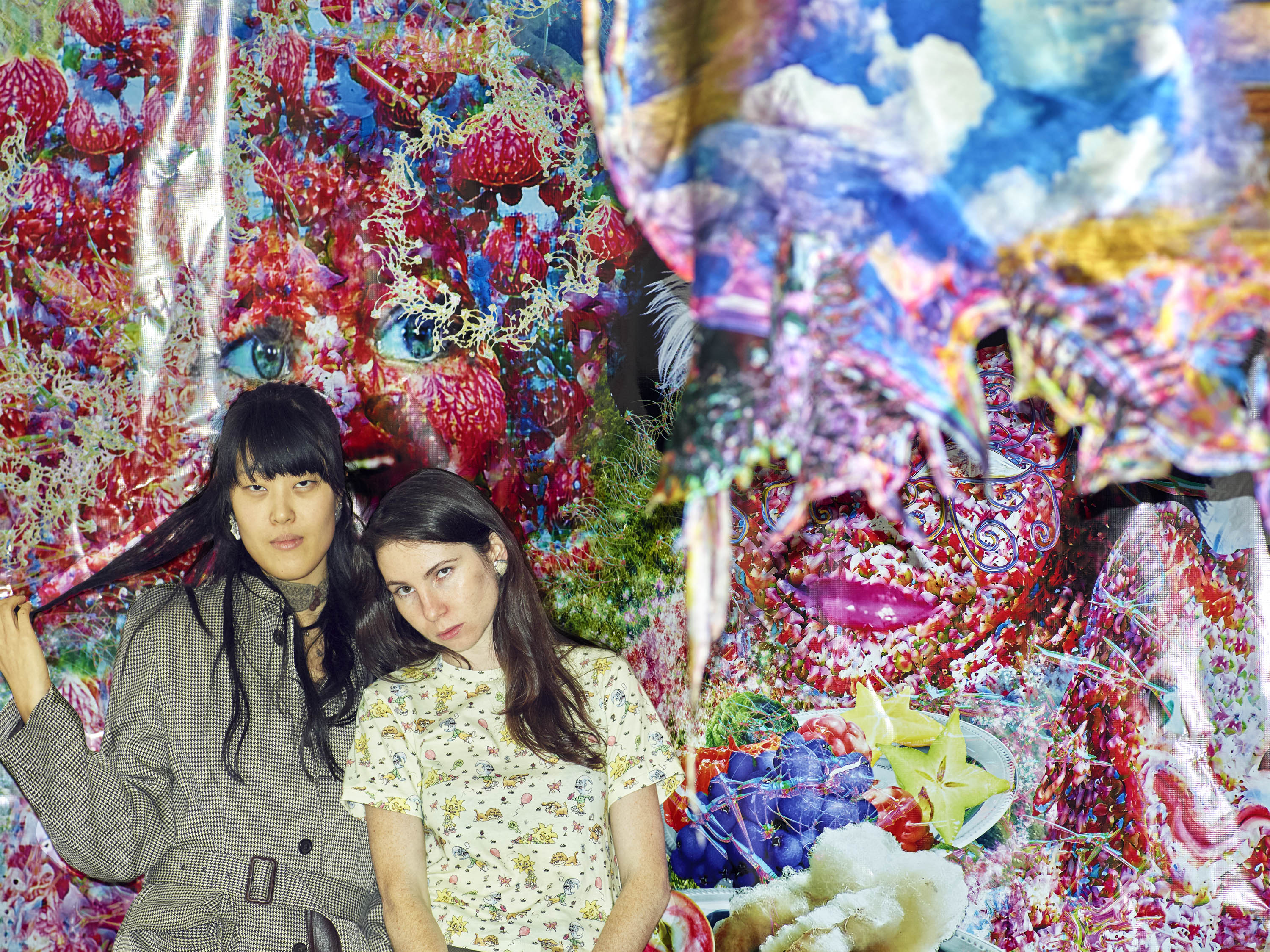 Jenny Cheng and Esther Gauntlett photographed in their Canal Street pop-up in front of a Jared Madere textile. 