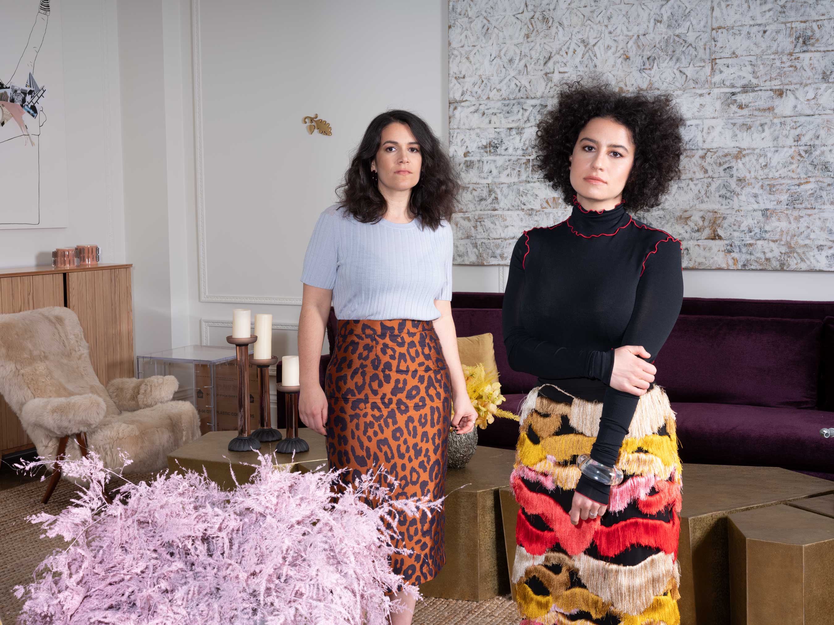 Jacobson and Glazer make themselves at home on the Upper East Side surrounded by contemporary masterworks. From left to right: a Frances Stark painting (2010), a brass wall relief by Louise Lawler and Alan McCollum (1988) and a Jasper Johns-inspired flag by Elaine Sturtevant (1991). Produced by Raquel Cayre, styled by Katie Christopher.