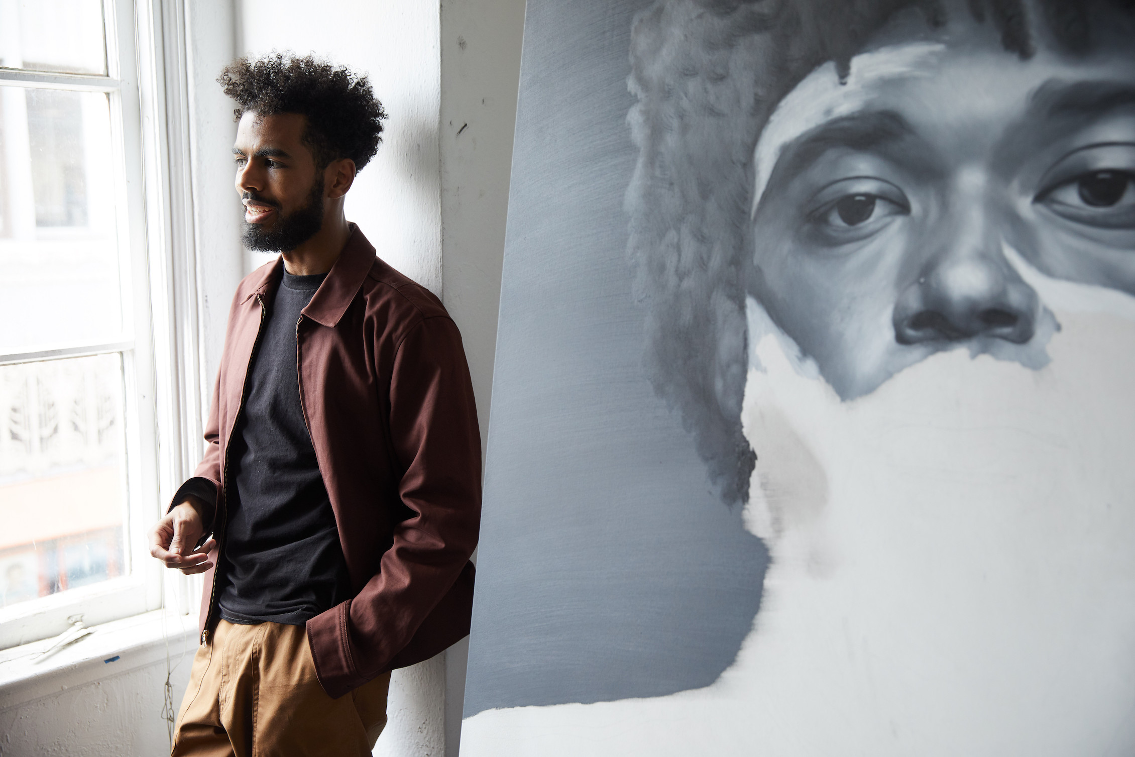 Kohshin Finley in his Hollywood studio with an in-progress portrait of his friend Antoine J. Girard.