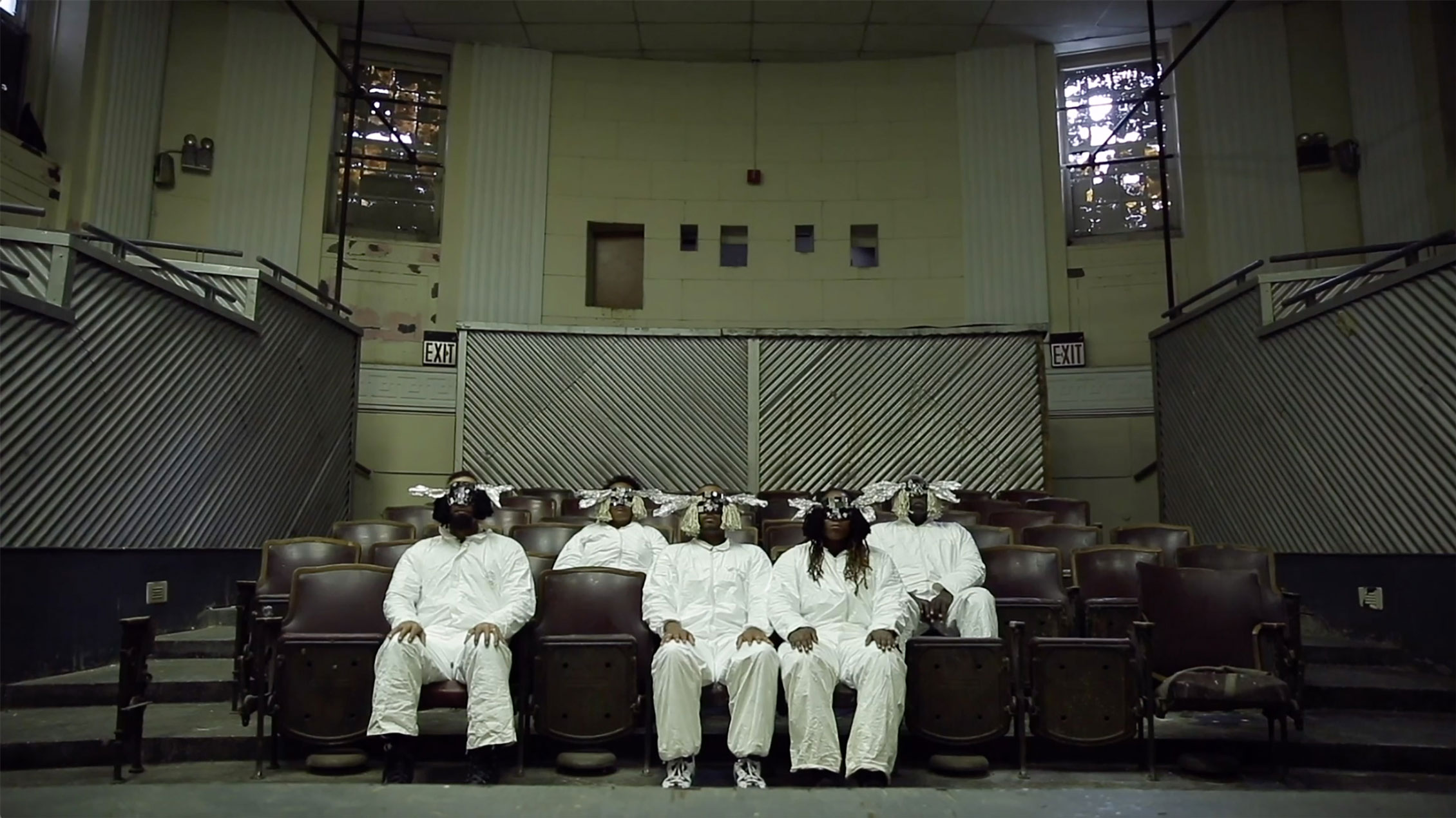 film still with people in chairs