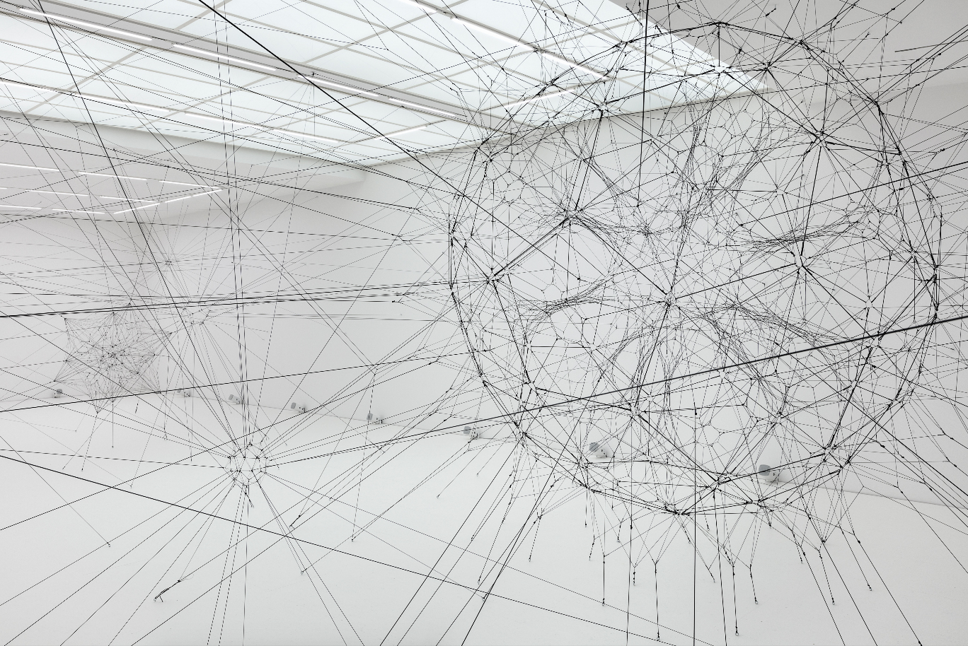An exhibition view of Tomás Saraceno's Algo-r(h)i(y)thms at Esther Schipper, Berlin, 2019.