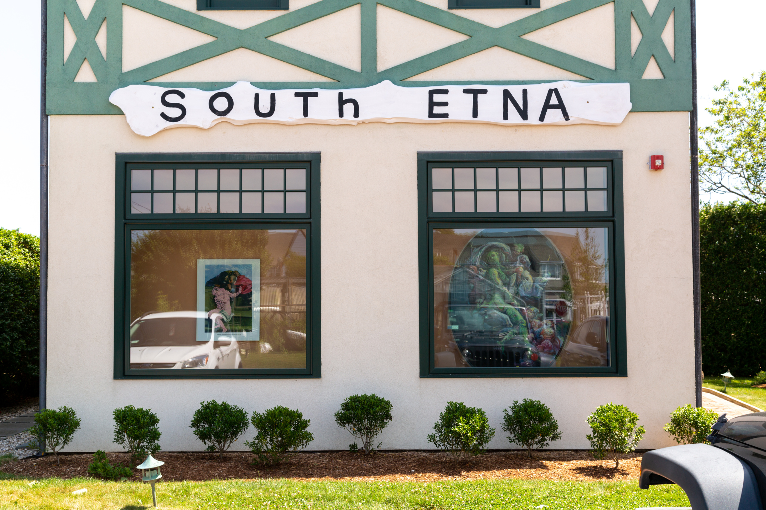 At South Etna Montauk, the gallery's sign was designed by Julian Schnabel. Artworks (in window) by Betty Tompkins (left) and Glenn Brown. Courtesy of South Etna Montauk.