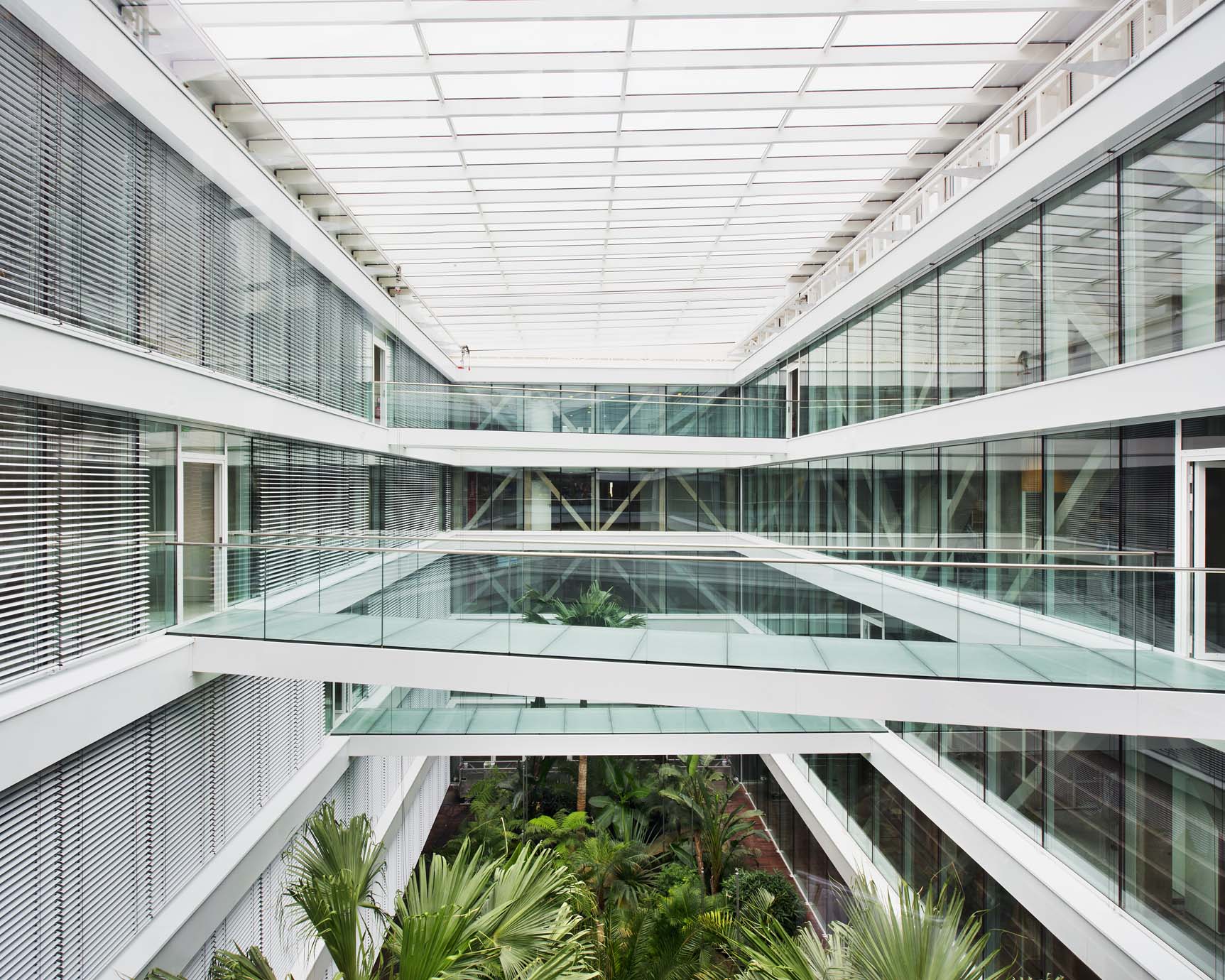 For the INPI headquarters in Courbevoie, France, a verdant garden courtyard forms the ecological heart of this biophilic and net positive energy building.