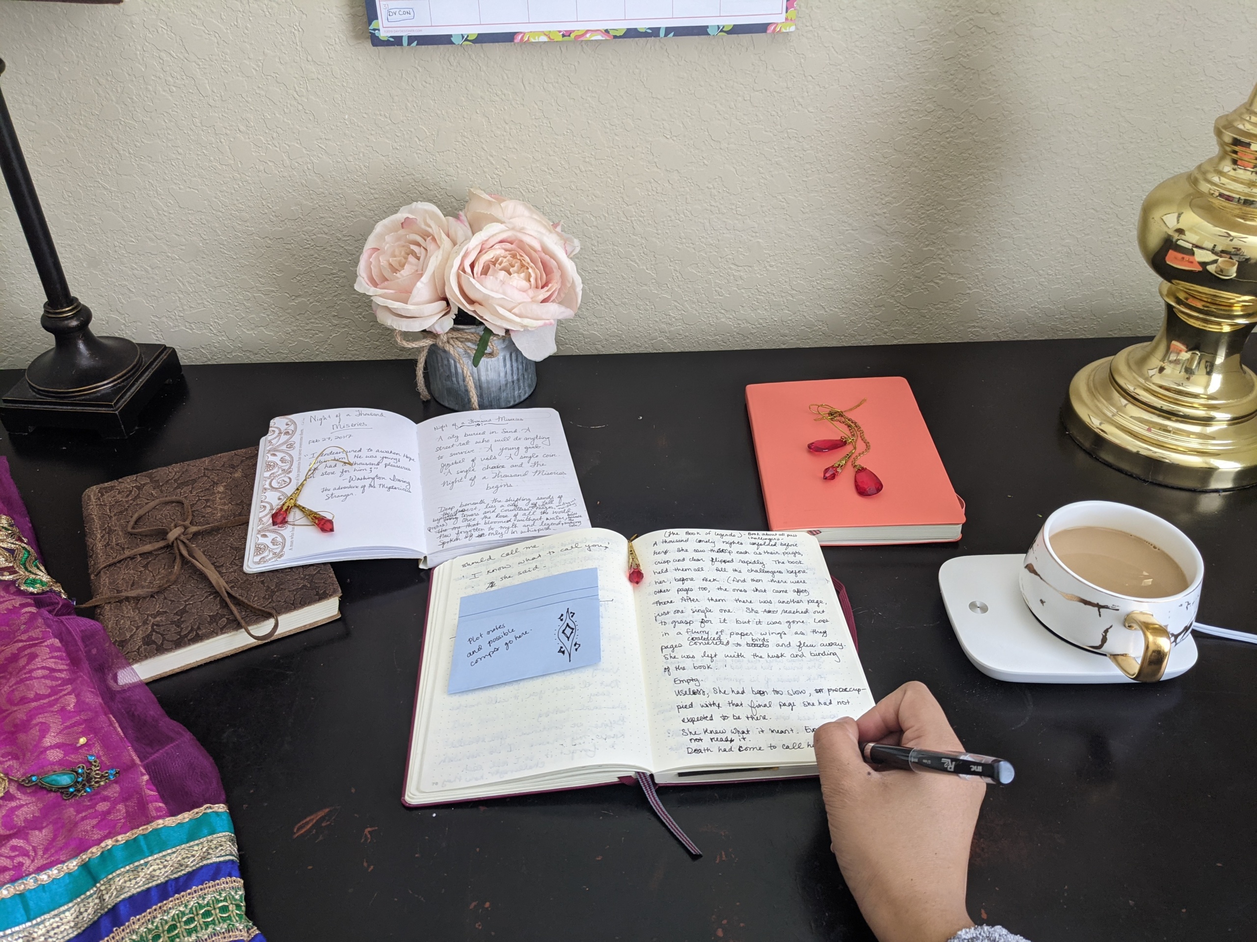 The desk of writer C.J. Hamilton, a student of Tomi Adeyemi's #WritersRoadmapxValentino writing workshop. Photo courtesy of C.J. Hamilton.