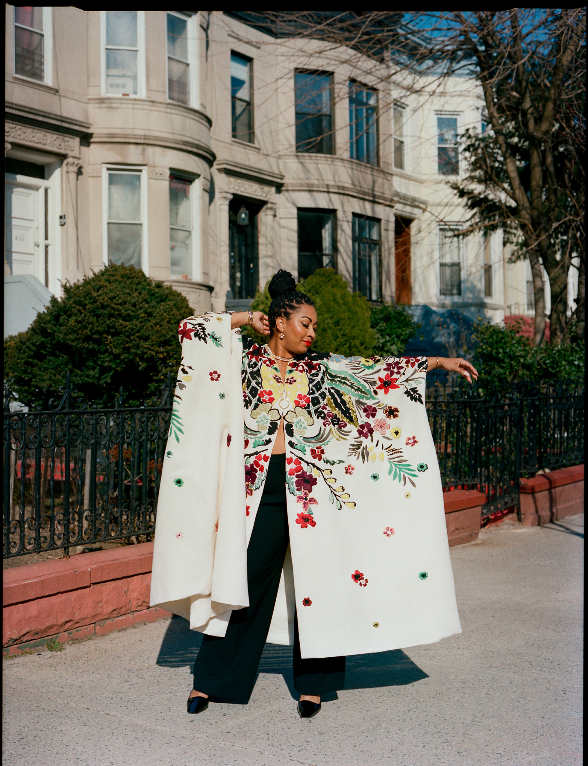 Rachel Cargle wears a Valentino robe, pants by Lafayette 148, shoes by Christian Louboutin and jewelry by Bulgari and Khiry. Styled by Becky Akinyode. Makeup by Jaleesa Jaikaran using Ilia Beauty.