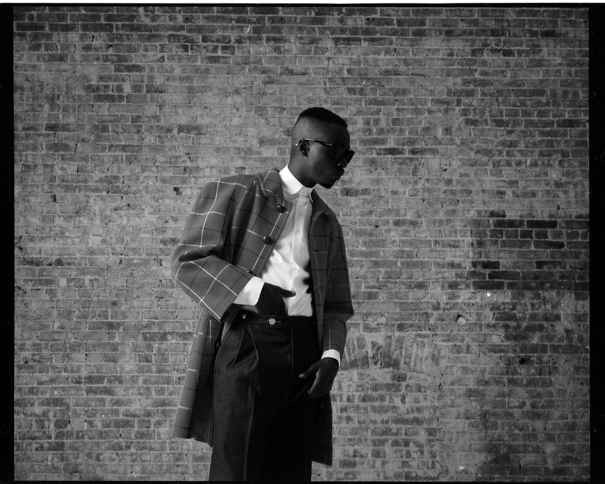 Ashton Sanders wears a Gucci look and Gentle Monster sunglasses. Styling by Jordan Boothe and Shannon Stokes. Grooming by Jessica Ortiz.
