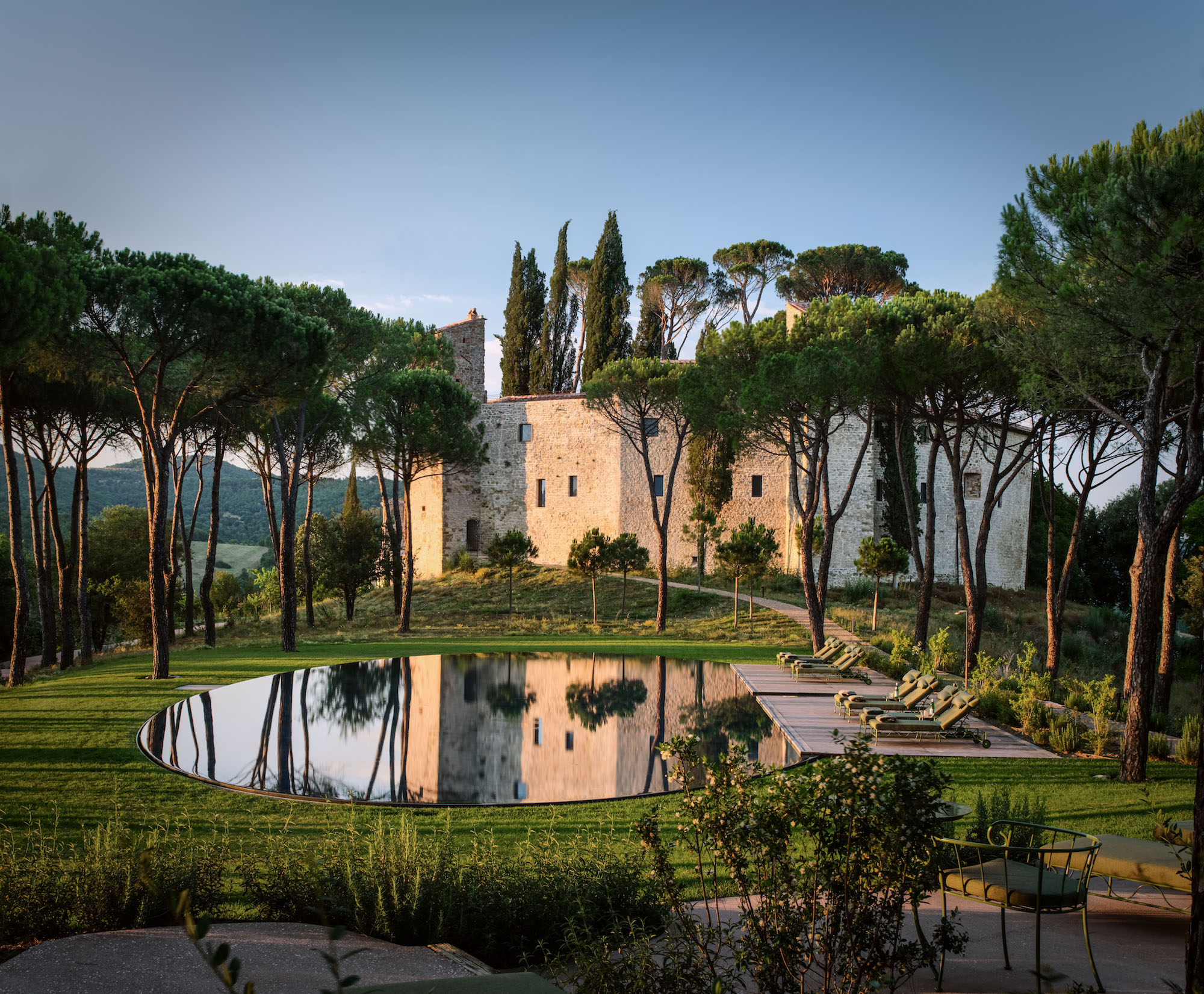 The 3,750-acre Castello di Reschio property includes a collection of private homes and the newly opened, 36-room boutique hotel housed within an 11th century castle. Just beyond the castle’s walls rests the oval-shaped swimming pool, designed to sit within the grass as if it were floating.