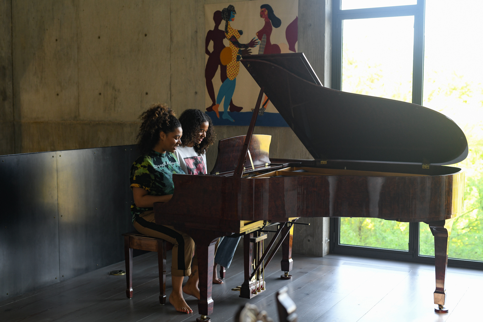 Two girls playing piano