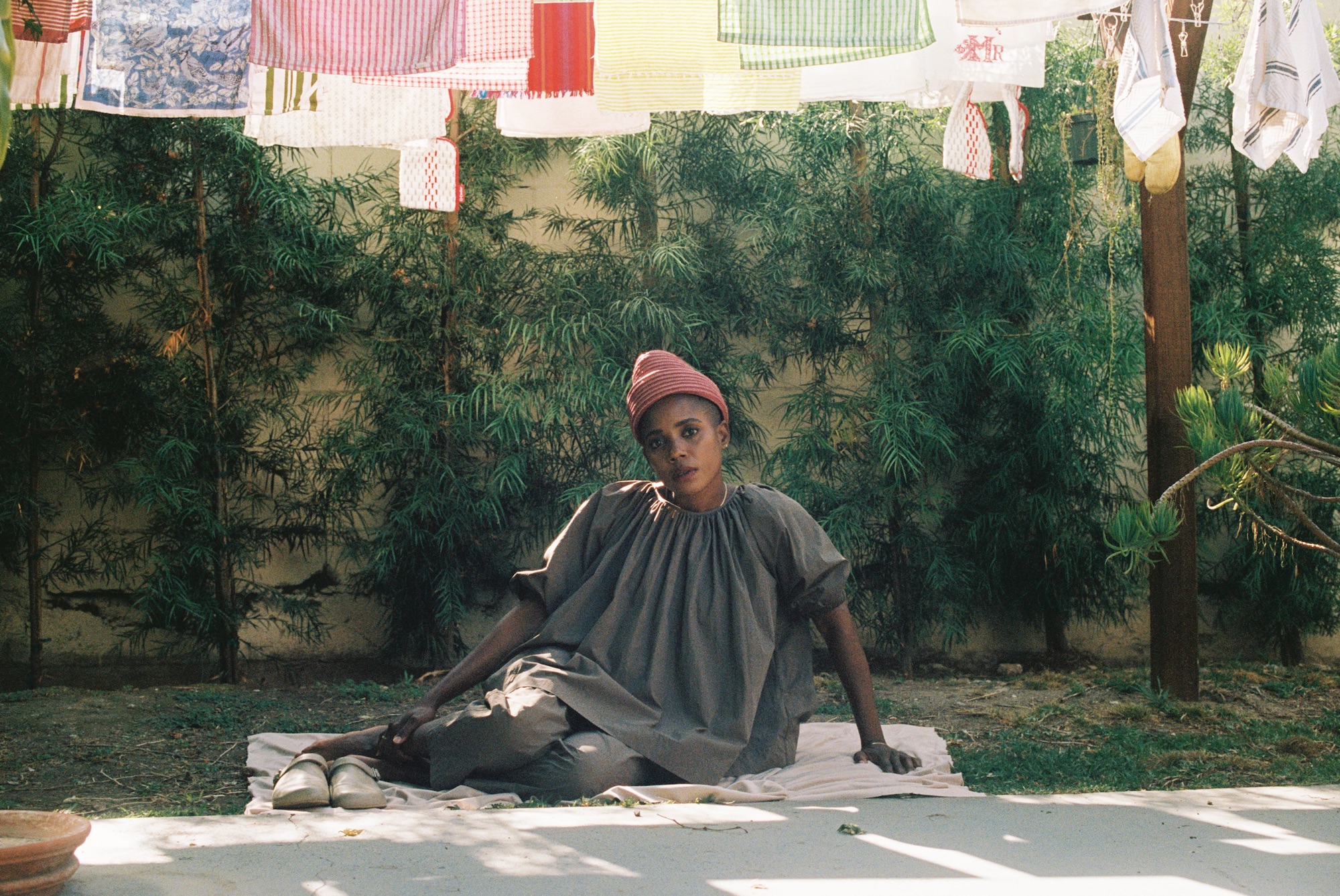 Woman sitting under clothesline