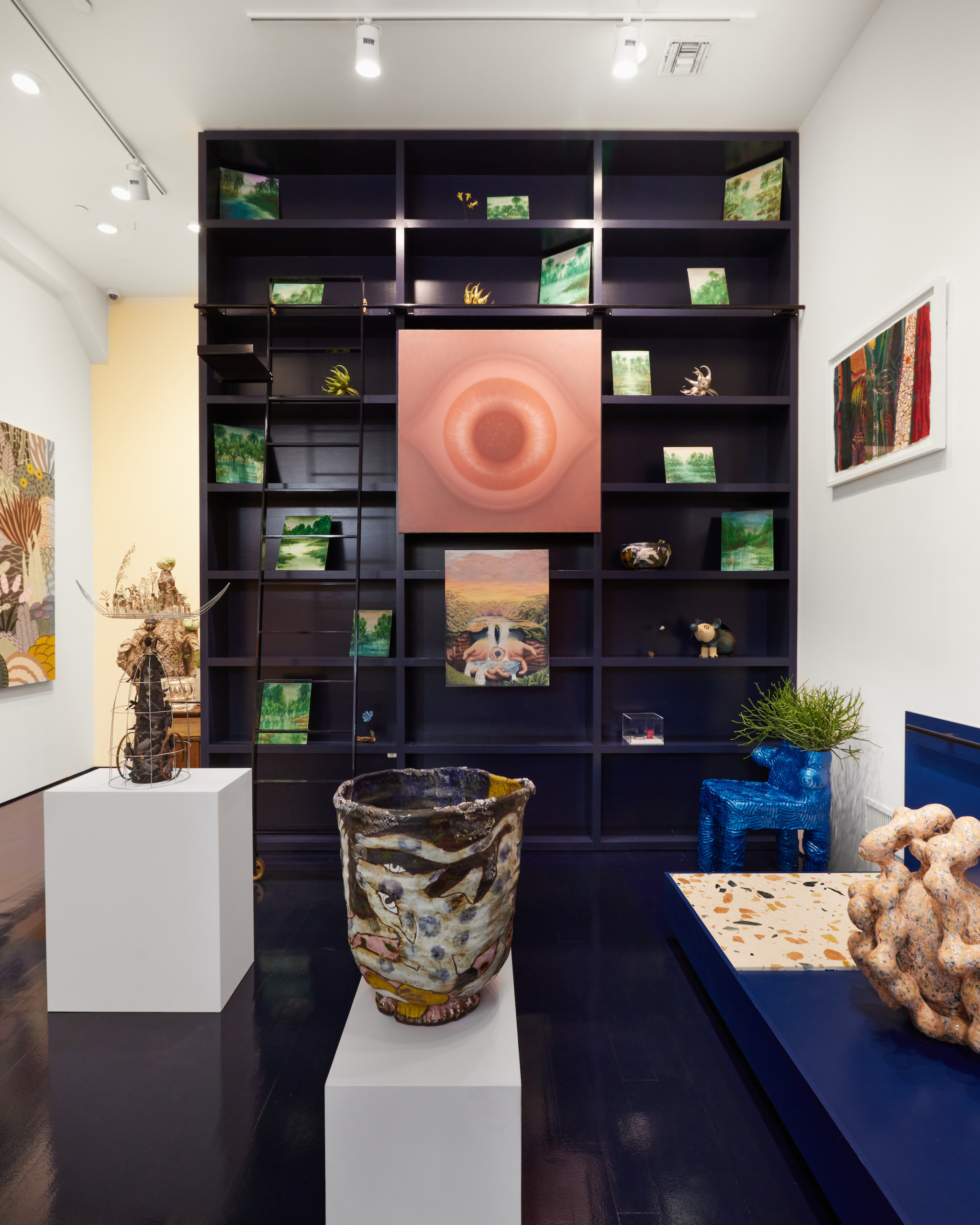 installation view of ridiculous sublime featuring work by Rodolfo Abularach and other artists, with ceramics and paintings