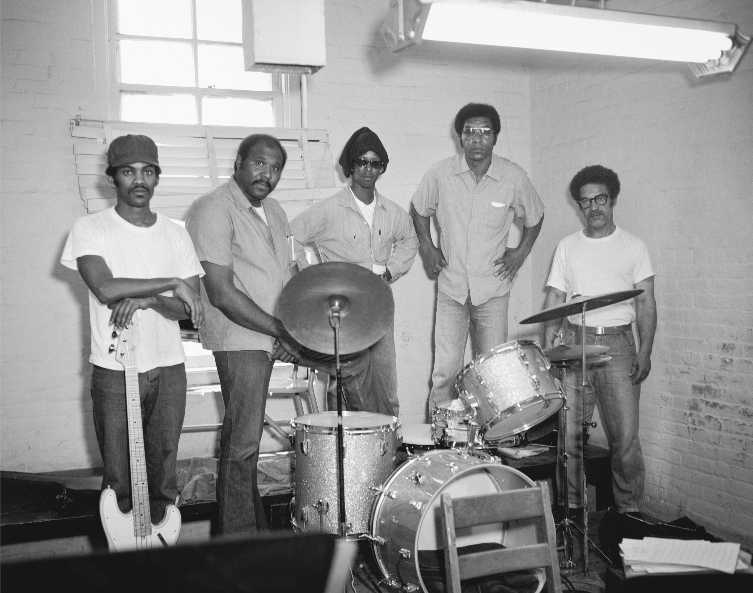 photograph of 5 men with band instruments in prison