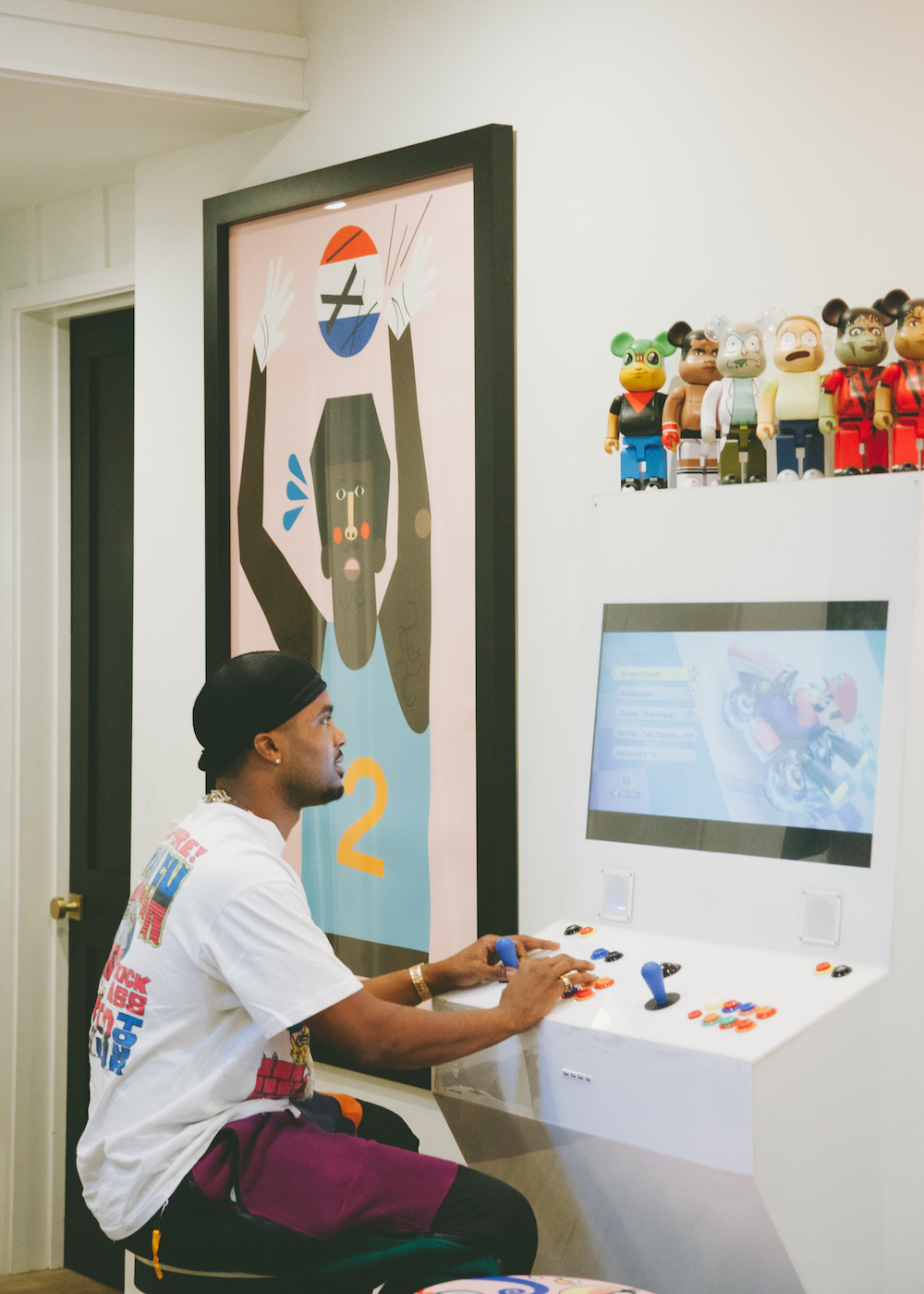 steelo brim playing a video game on white modern looking console