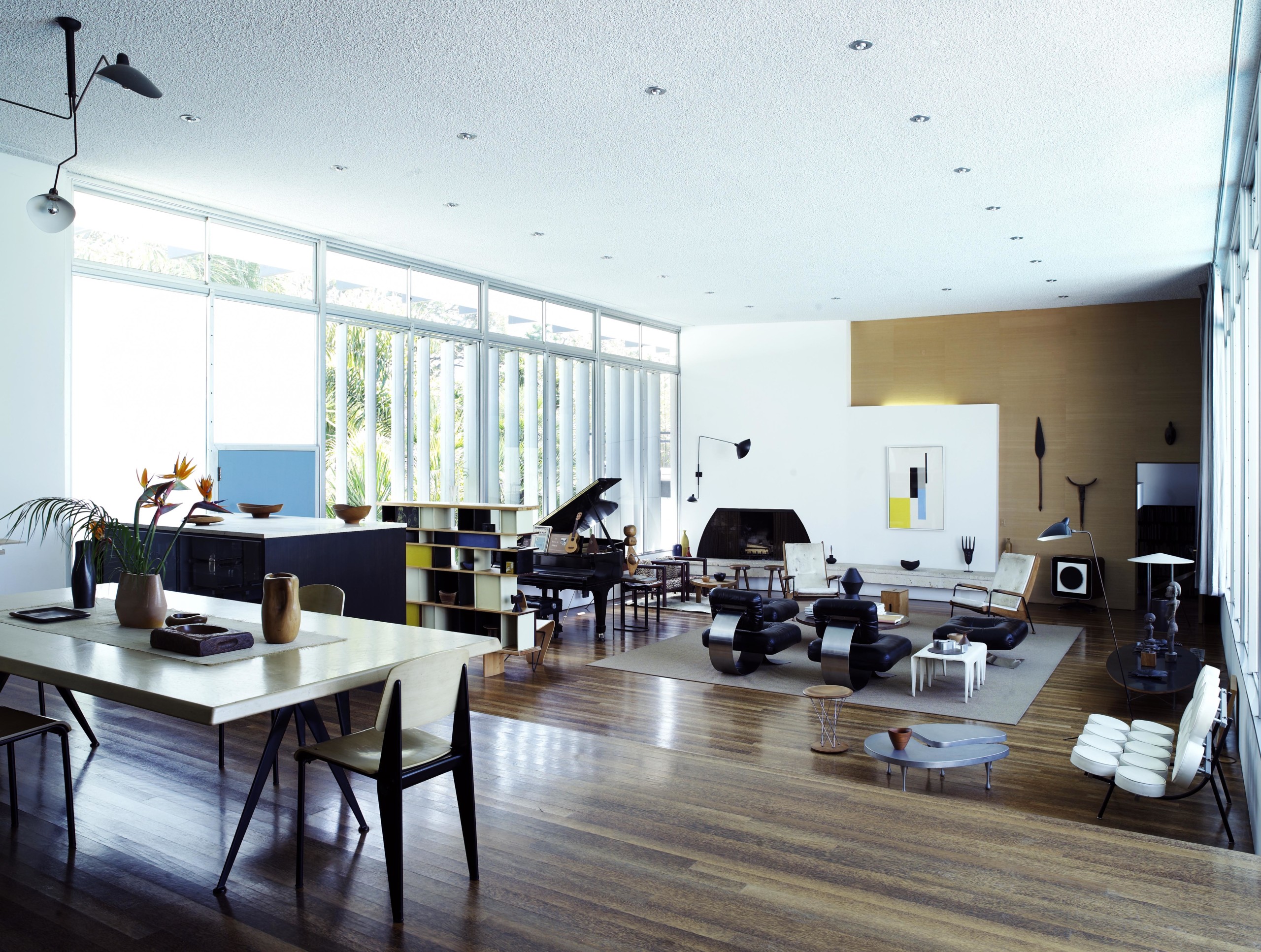 The open plan living and dining room of Michael Boyd's Santa Monica home, featuring pieces by Oscar Niemeyer, Charlotte Perriand, Marcel Breuer, Isamu Noguchi and Serge Mouille.