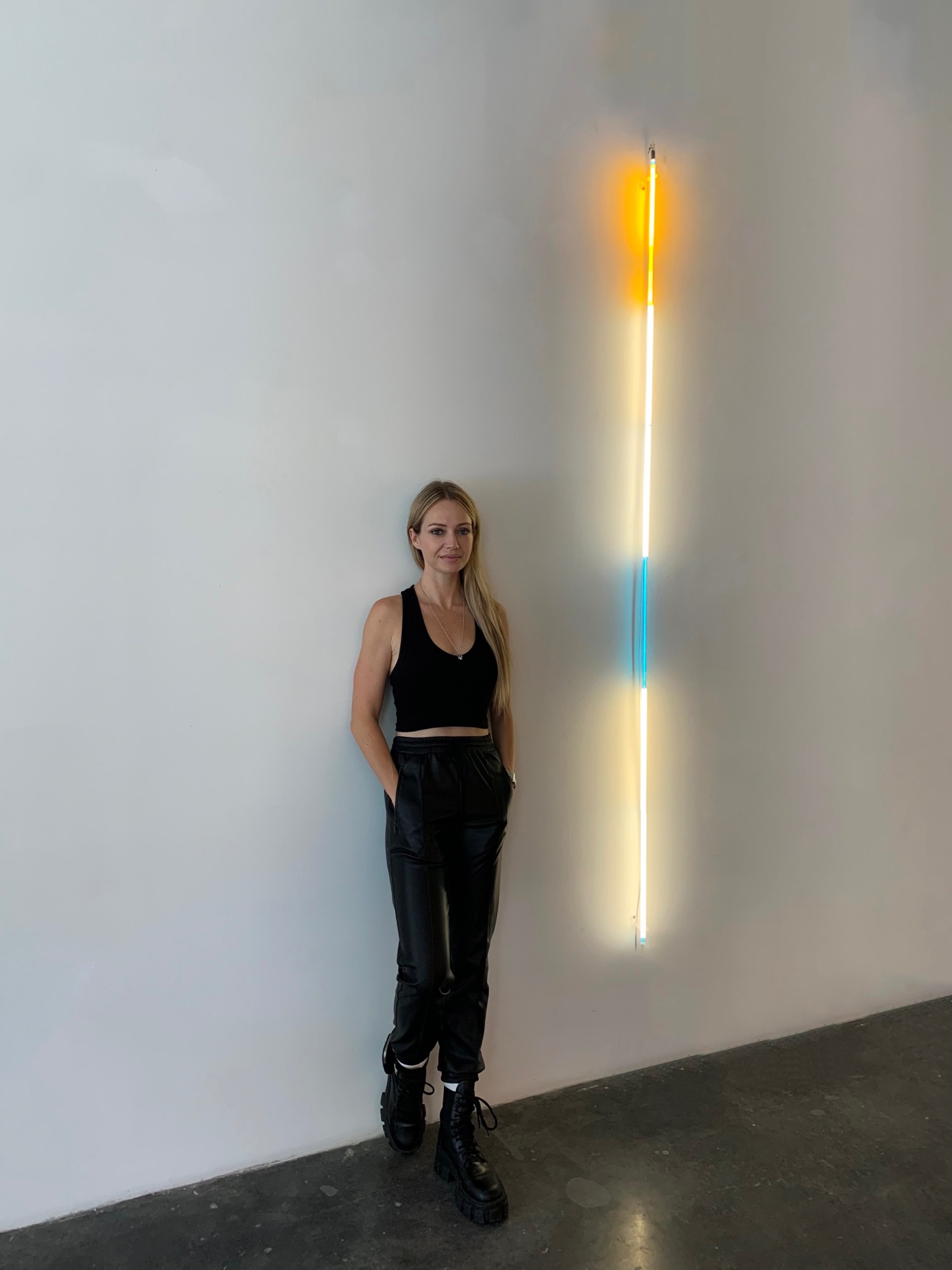 anna hygelund posing in front of laddie john dill light sculpture