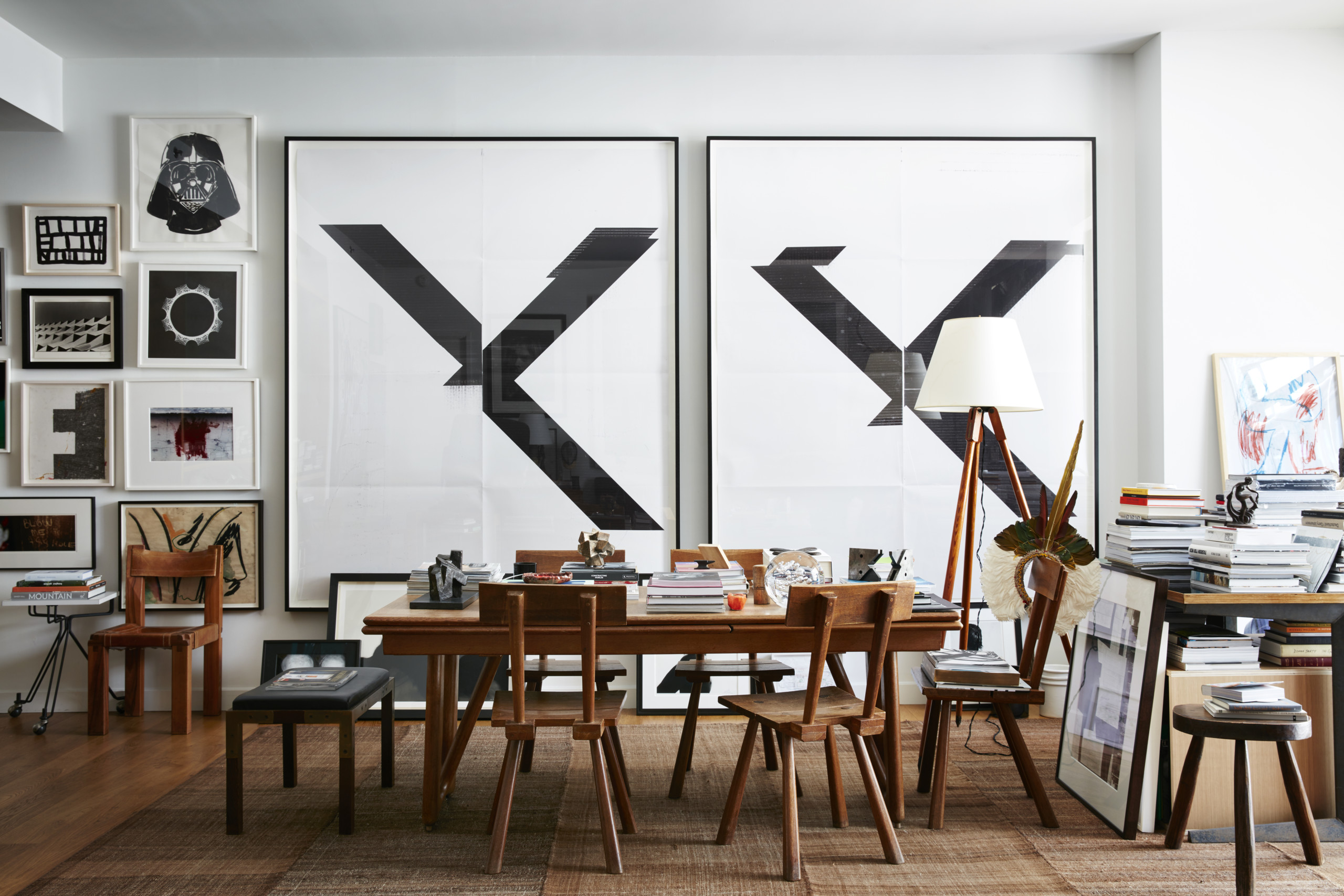 robert stilin desk space with piles of books