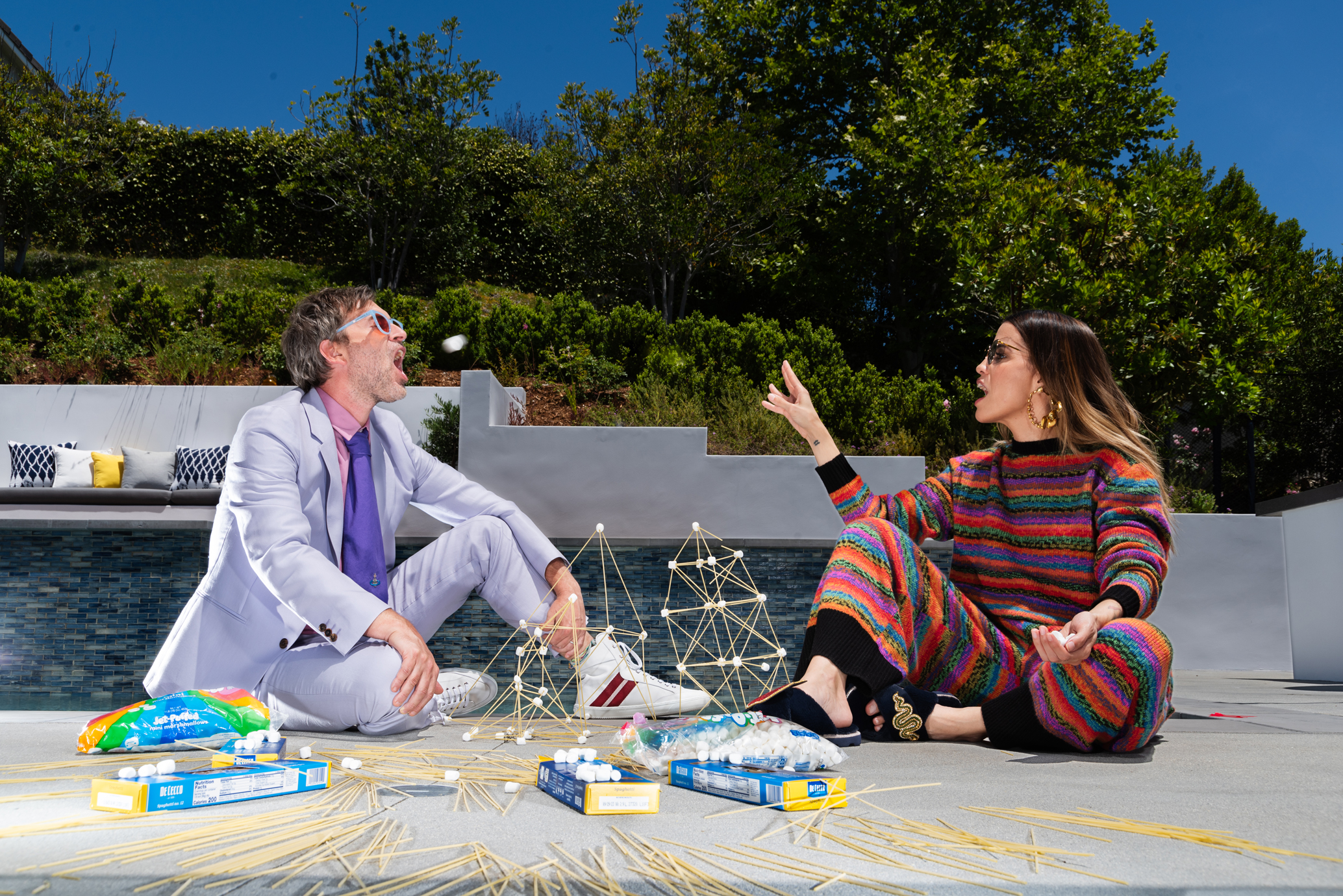 Duplass wears Paul Smith suit, Dries Van Noten shirt, Vivienne Westwood tie, Bally shoes and Gentle Monster sunglasses. Morales wears The Elder Statesmen top and pants, Laines London slippers and Misho earrings. Mark Duplass styled by Jules Wood. Natalie Morales styled by Kimmy Erin. Hair and makeup by Diana Ivanov. Photo assistance by Jonathan Chacon. Special thanks to the Isrow family for their generous hosting.