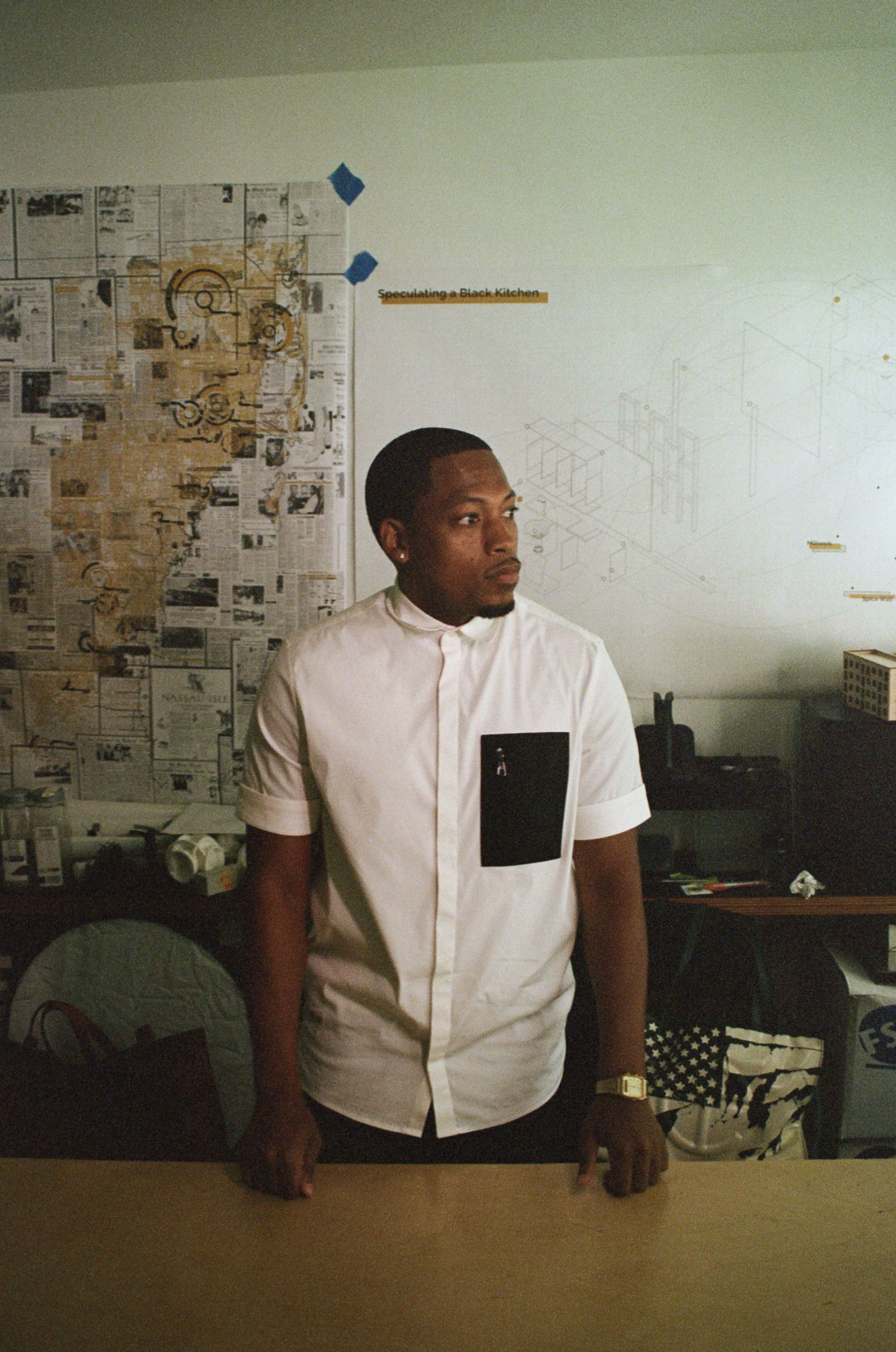 Designer Germane Barnes in his studio at the University of Miami School of Architecture, where he is an assistant professor and director of the Community Housing Identity Lab. Lighting assistant: David Ortiz. Photography assistant: Helen Peña.