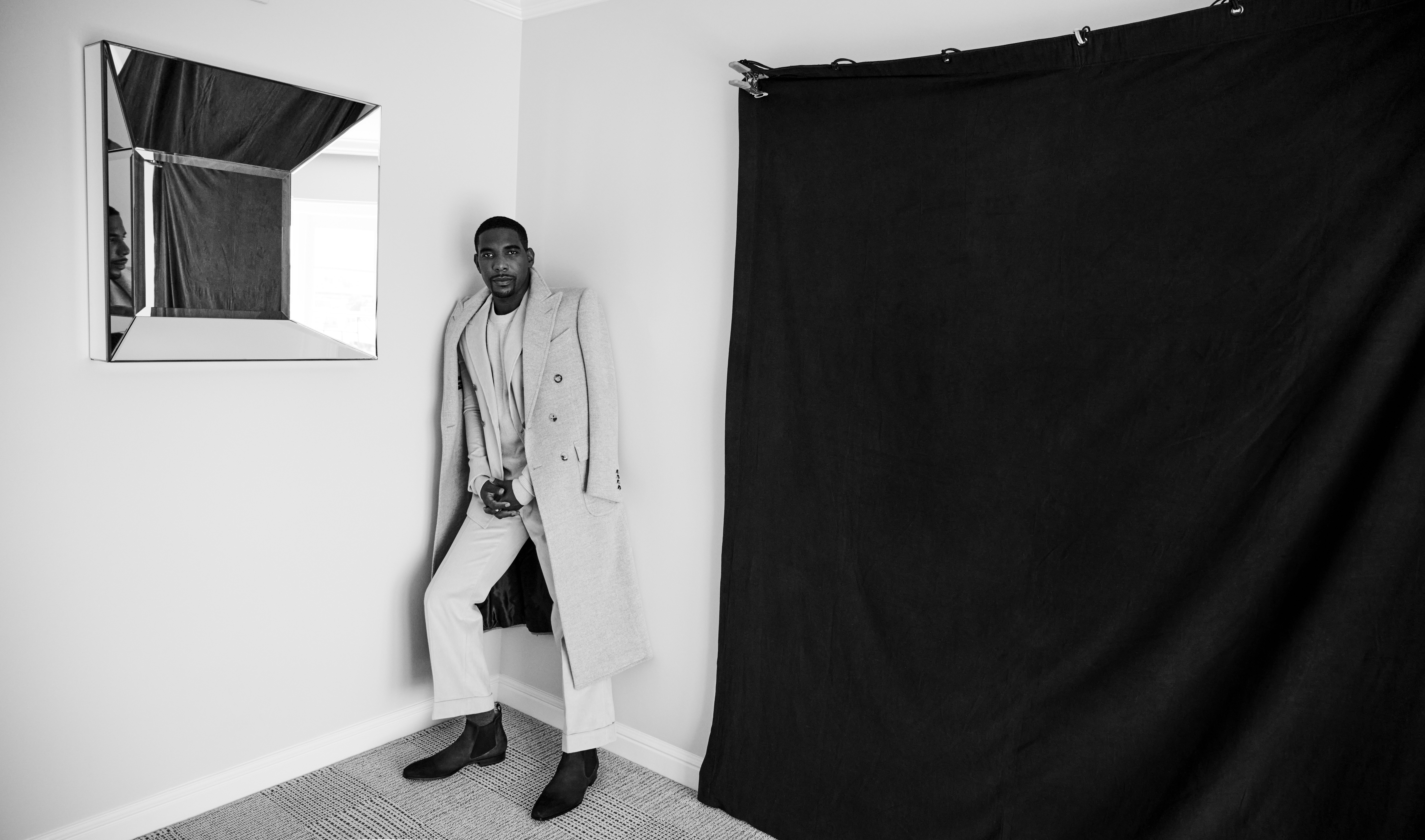 Desean Terry wears a suit and overcoat by Devon Scott, sweater by Buck Mason, shoes by Magnanni and ring by David Yurman. Styling by Courtney Mays. Grooming by Sonia Lee. 