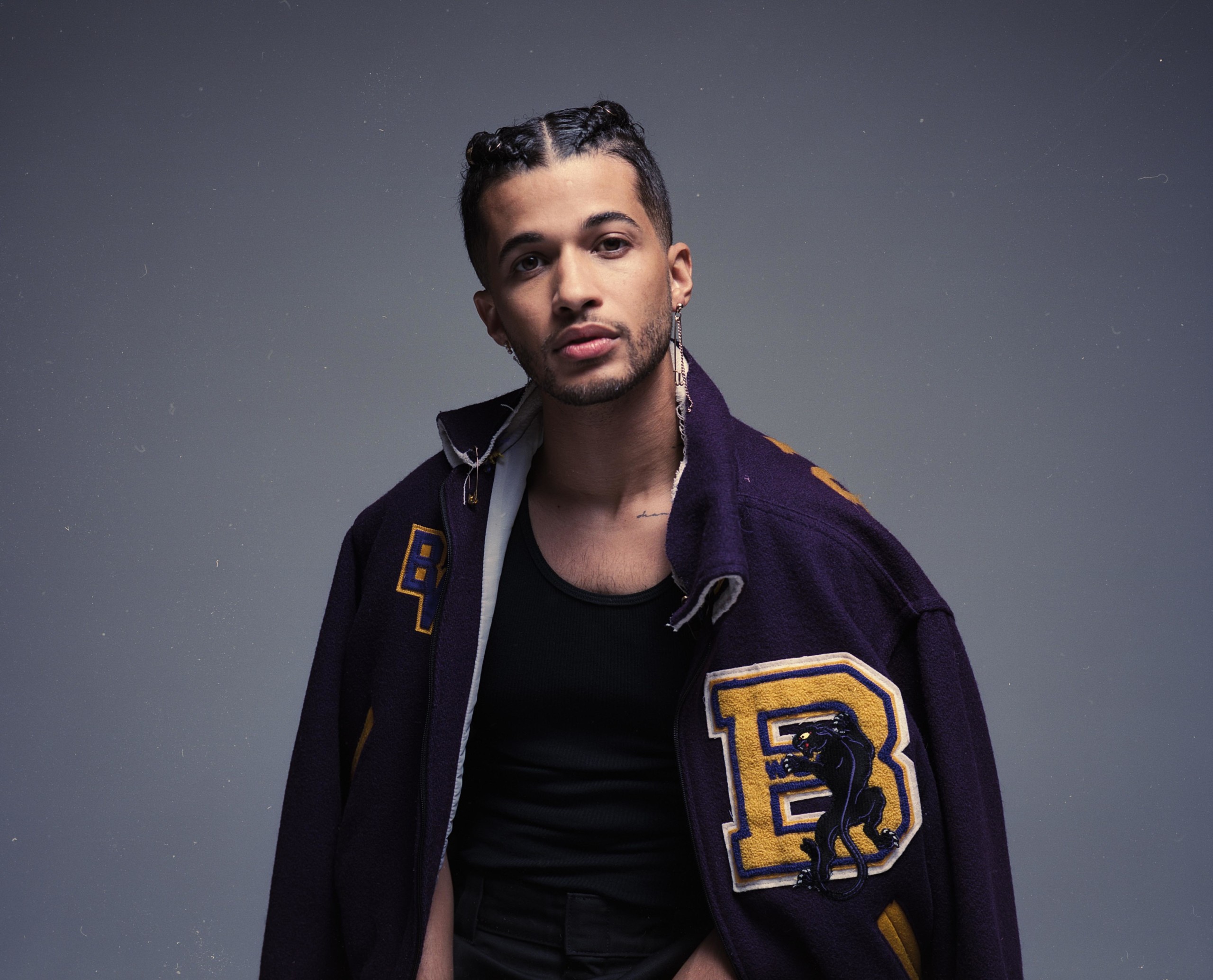 Jordan Fisher wears a jacket by Toussaint L'Overture and shirt by Hanes. Styling by Veronica Graye. Grooming by Erica Whelan using Jaxon Lane. Braids by Star Appling.