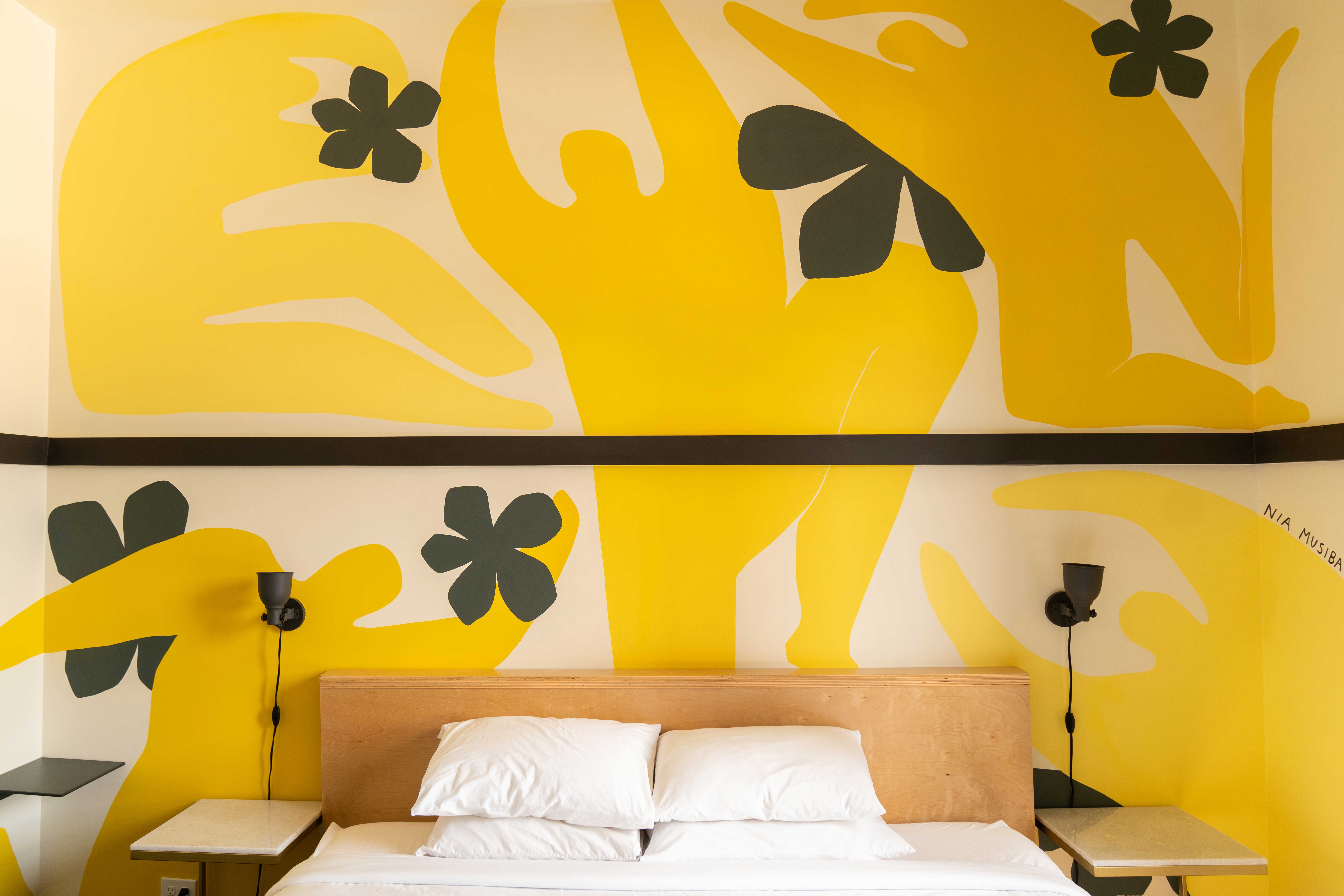 A room in the Society Hotel featuring a mural by Nia Musiba. Photography by Maria Orlova, WE ARE PDX.