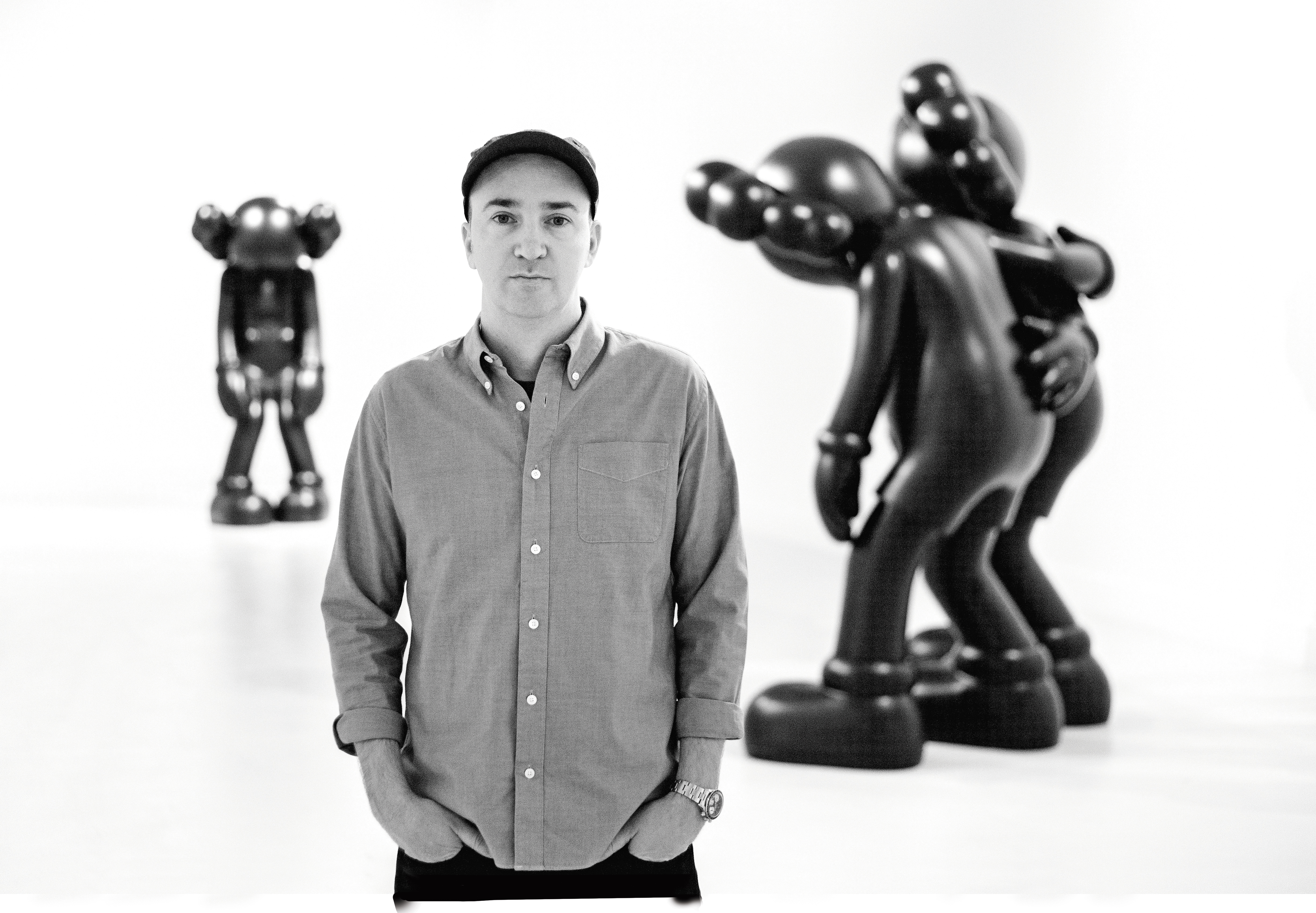 Brooklyn-based artist Brian Donnelly—a.k.a. KAWS—with his sculptures Small Lie (left) and Along the Way.
