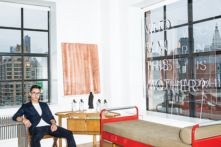 Ed Tang in his New York apartment with artwork by Danh Vo, Karl Holmqvist and Katharina Fritsch and furniture by Jean Prouvé and Pierre Jeanneret. 