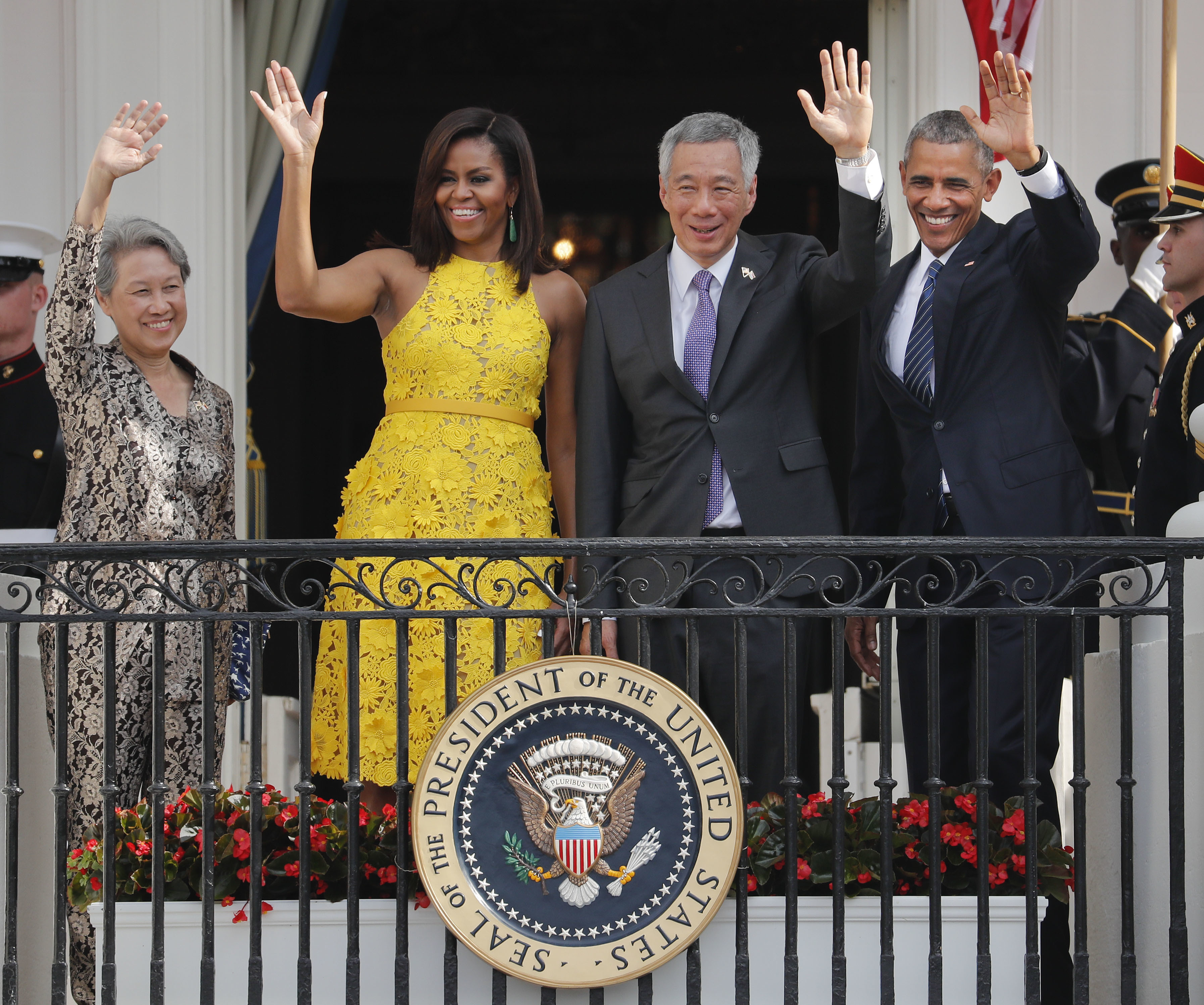 President Barack Obama, first lady Michelle Obama, Singapore's Prime Minister Lee Hsien Loong and his wife Ho Ching, wave from the Truman Balcony of the White House in Washington, during a state arrival ceremony, Tuesday, Aug. 2, 2016. (AP Photo/Pablo Martinez Monsivais)