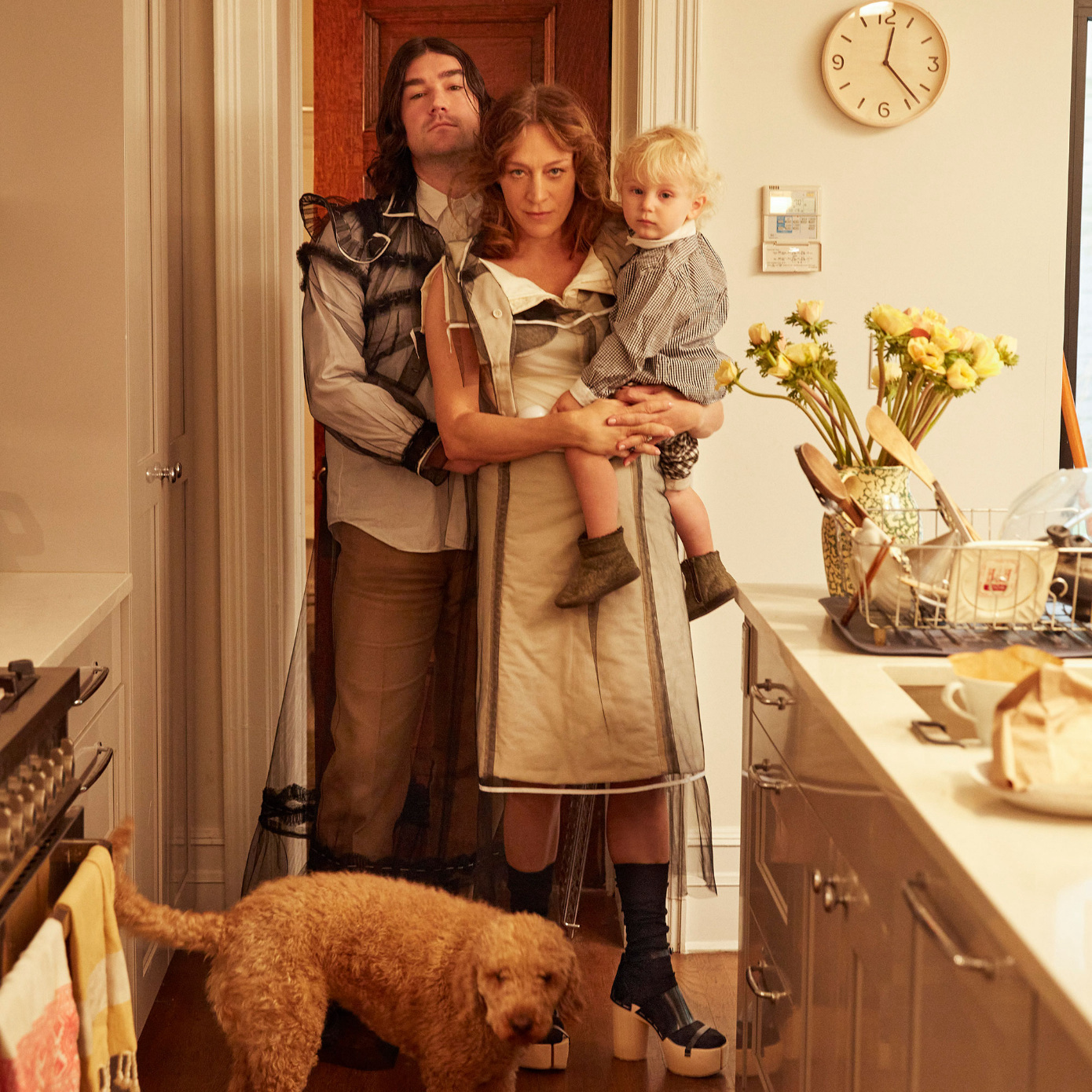 family in kitchen with baby and dog
