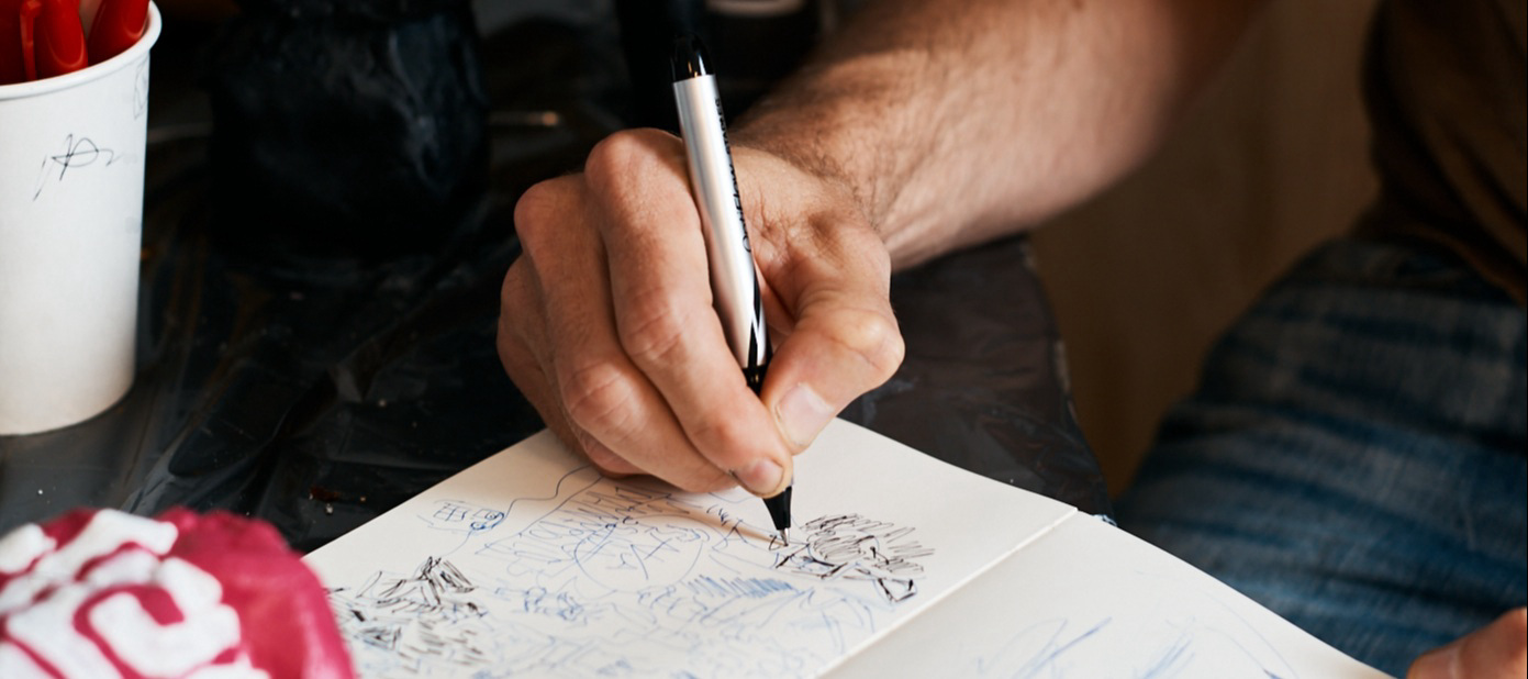 Will Ryman drawing in his sketchbook.