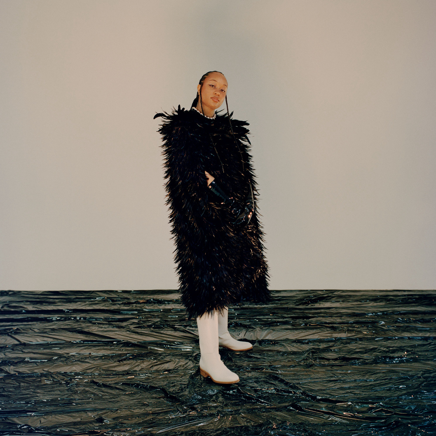woman standing in feather jacket