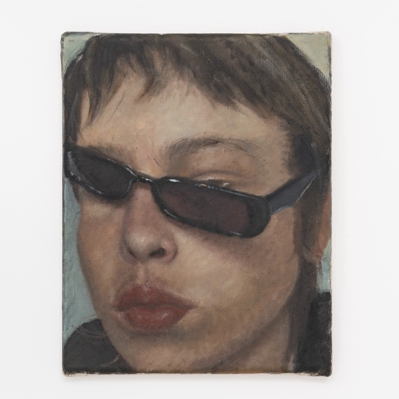 A self-portrait of a woman with sunglasses hanging off face.