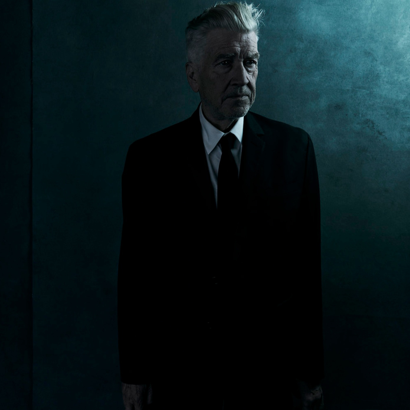 David Lynch photographed in a dark room.