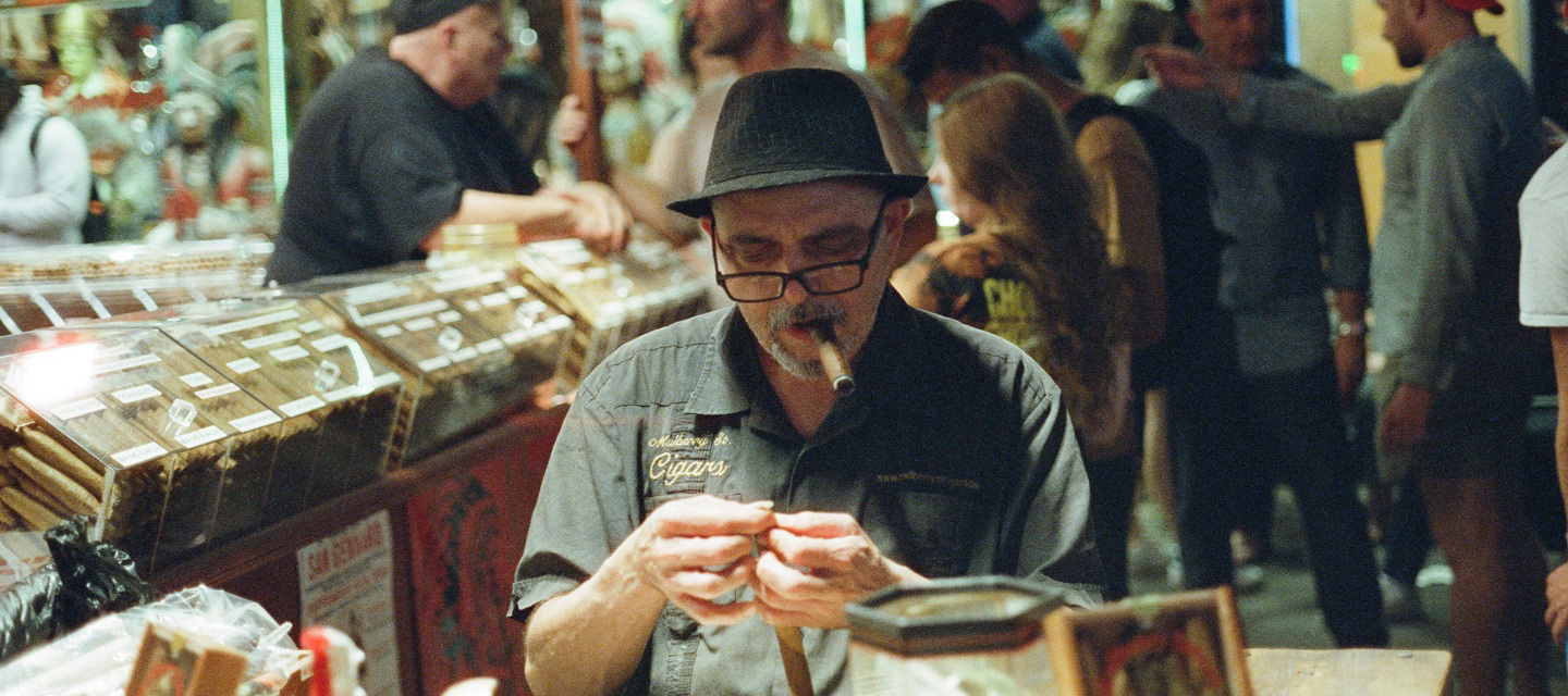A man smoking a cigar Dimes Sqaure.