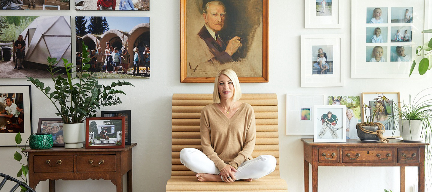 Heidi Zuckerman sitting on a wooden chair.