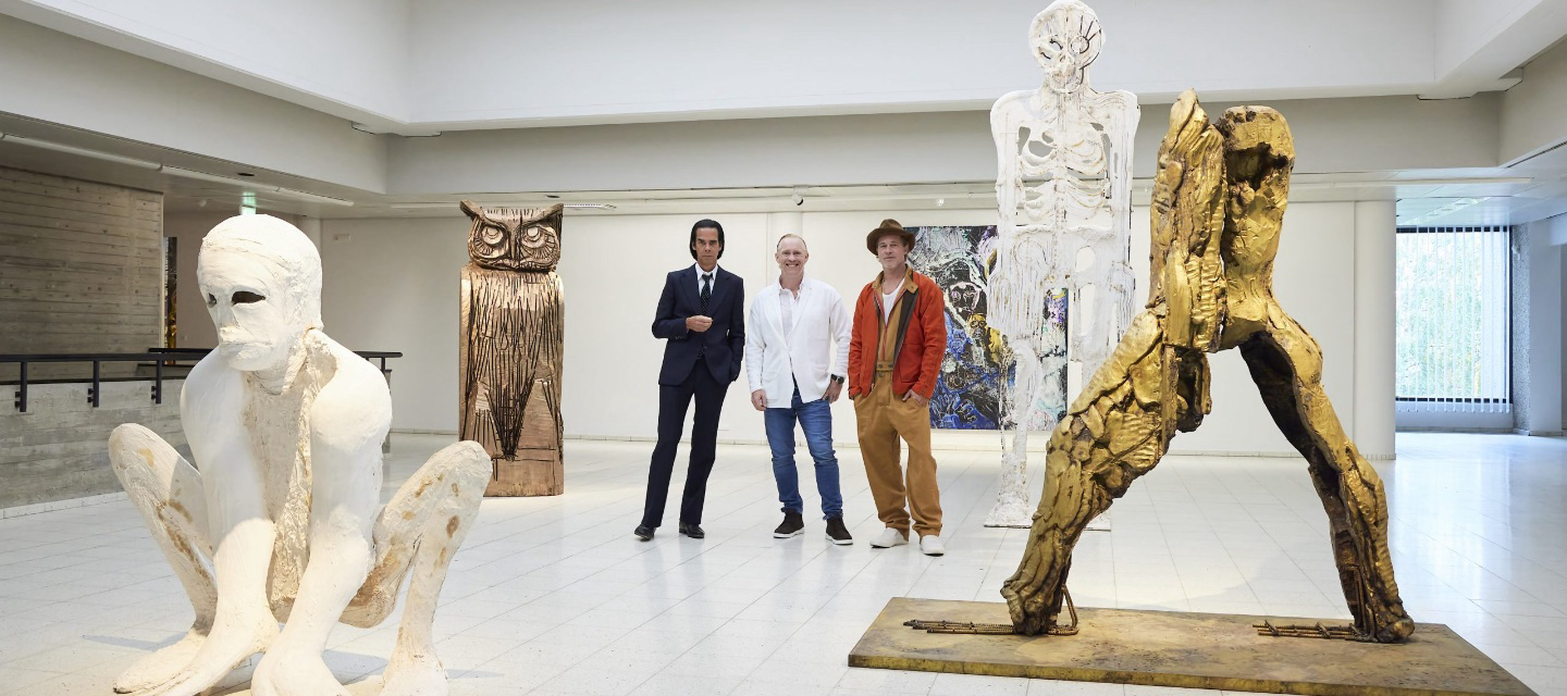 Nick Cave, Thomas Houseago and Brad Pitt pose with sculptures at the night before the opening of their joint exhibition. Photo courtesy of Jussi Koivunen/Sara Hilden Art Museum, Lehtikuva via AP