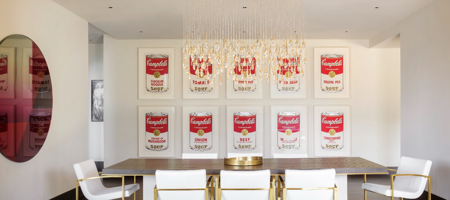 Andy Warhol's <em>Campbell's Soup Cans</em> in a dining room.