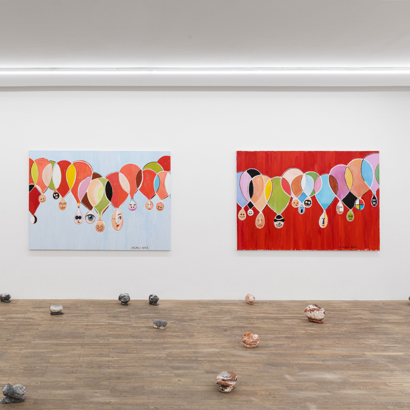 paintings on wall, sculptures on floor