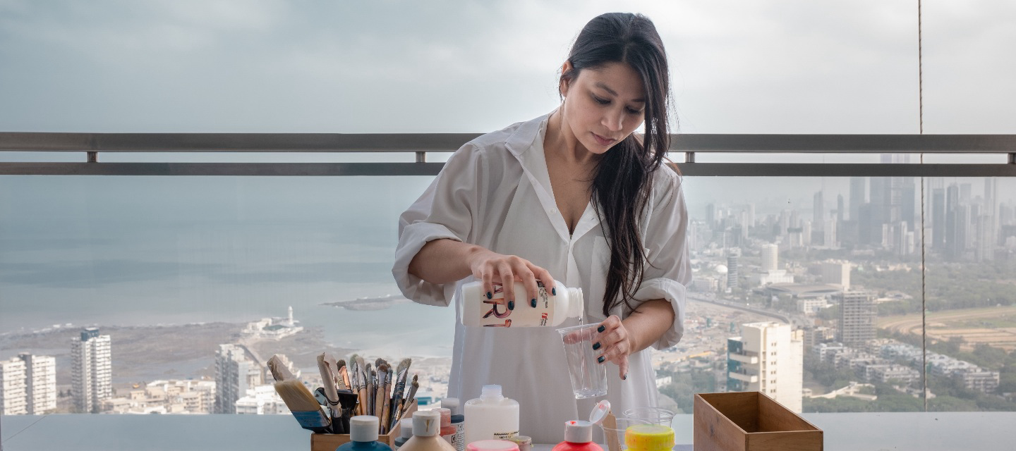 Designer Shwetambari Mody mixing colors to dye clothing.