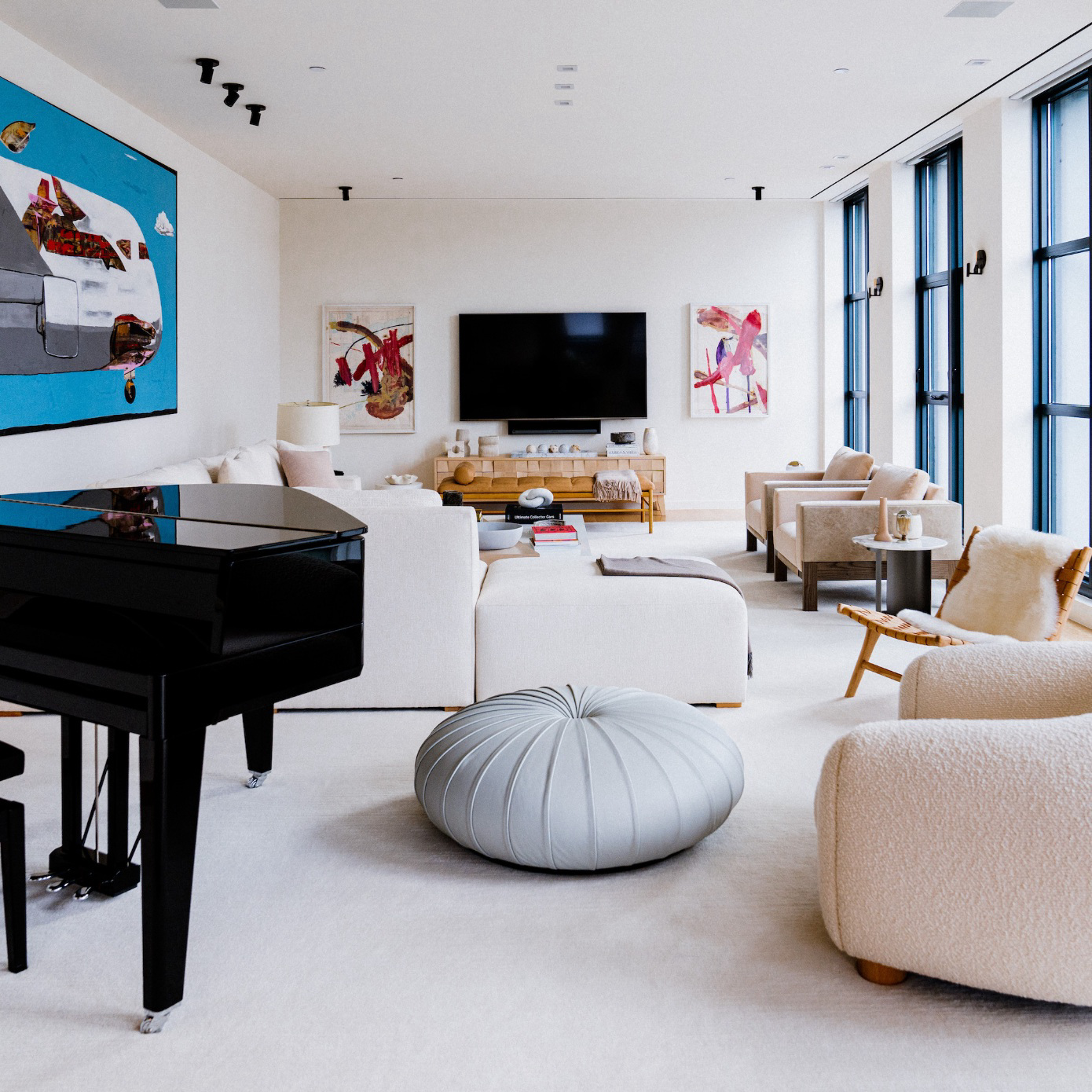 living room space with grand piano, art, and chairs