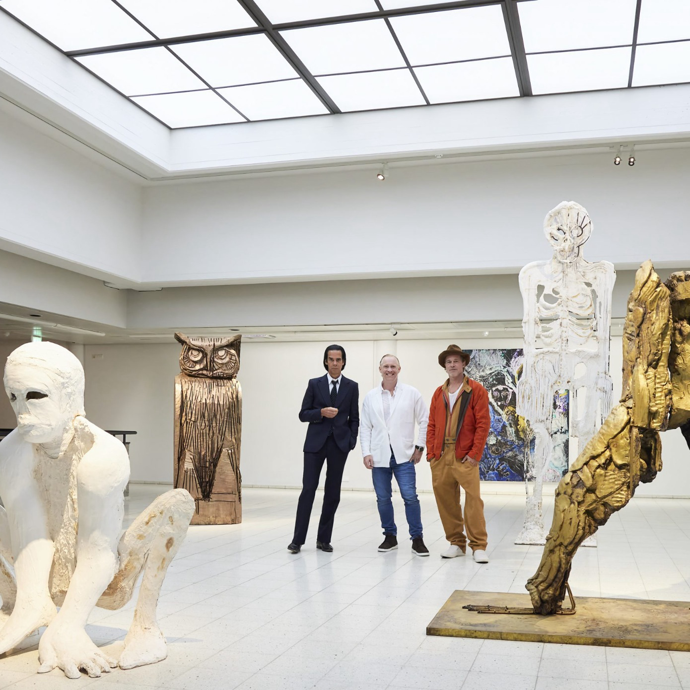 Nick Cave, Thomas Houseago and Brad Pitt pose with sculptures at the night before the opening of their joint exhibition. Photo courtesy of Jussi Koivunen/Sara Hilden Art Museum, Lehtikuva via AP