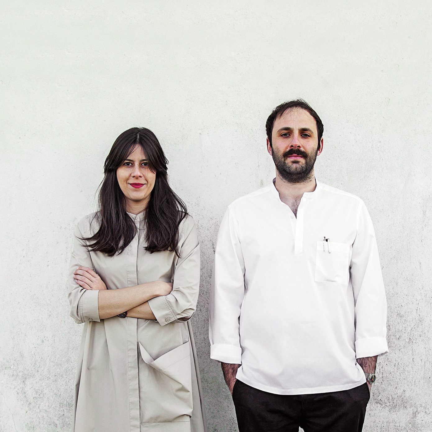 man and woman standing against wall