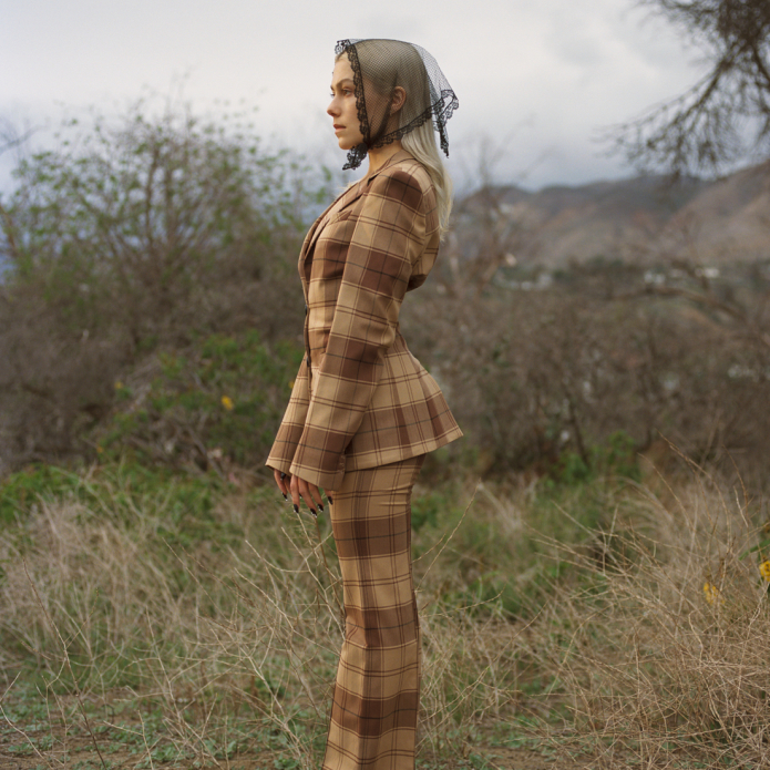 woman standing in plaid suit