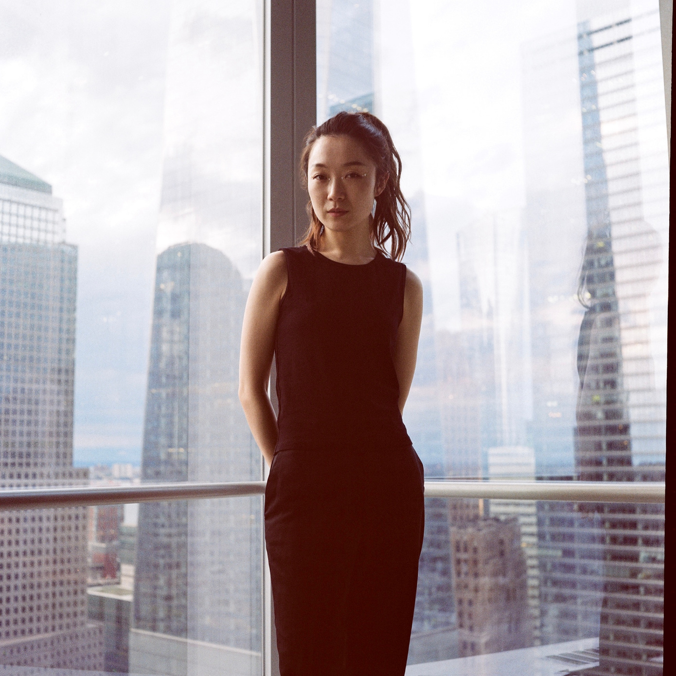 woman standing in skyscraper window